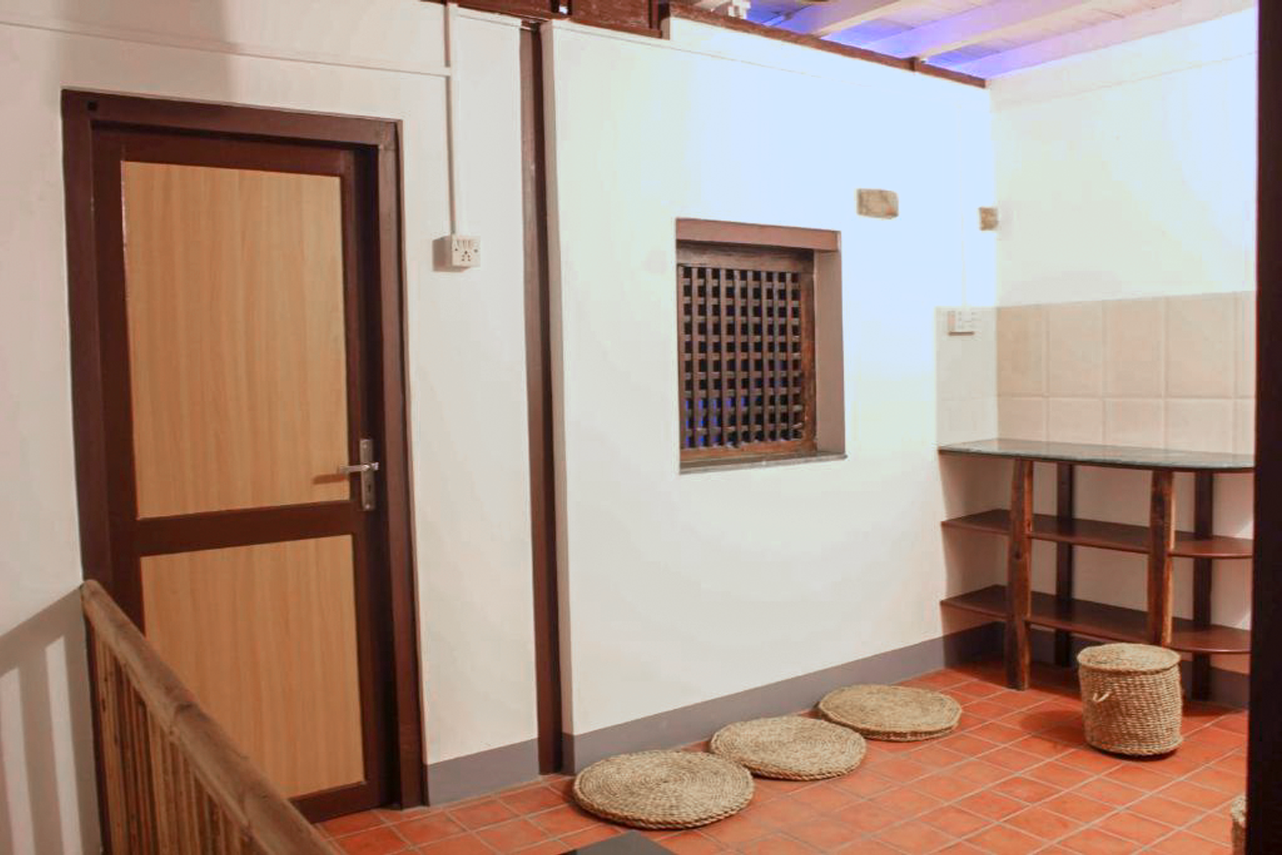 Mahakali private kitchen beside a carved window and floor cushions