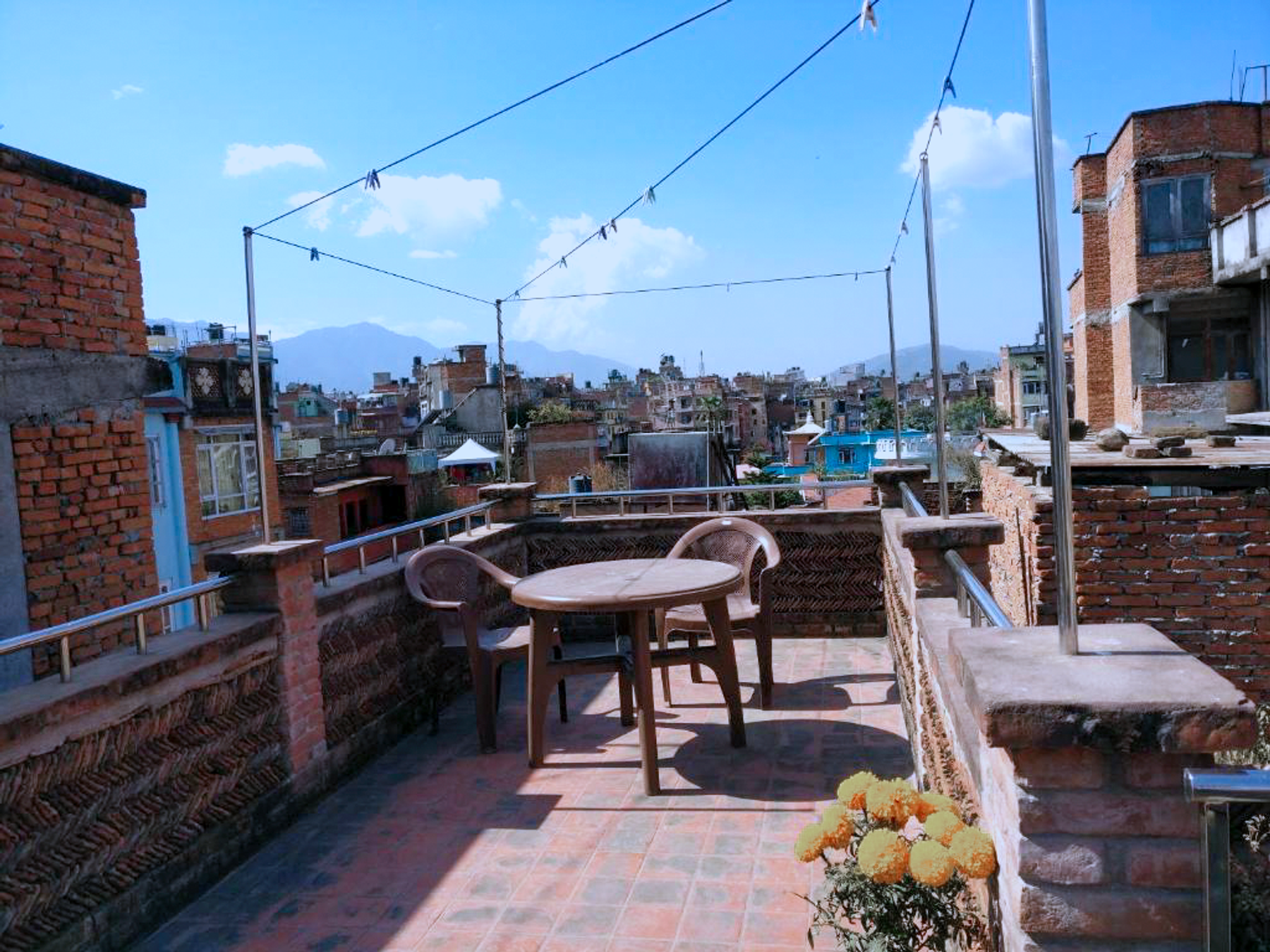 Round table and chairs overlooking Patan from the shared rooftop