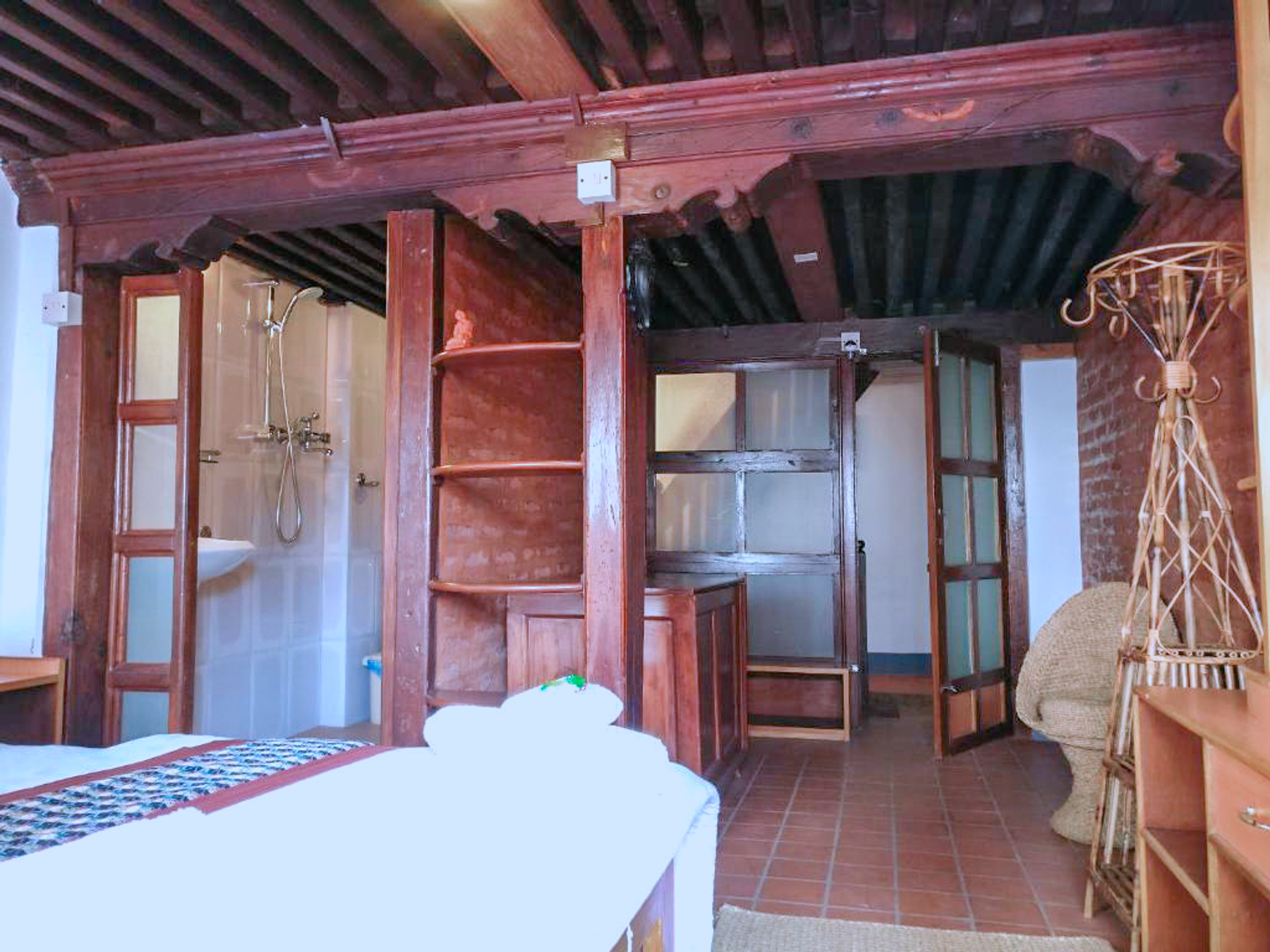 Rudrayani bed facing the window and wooden wardrobe