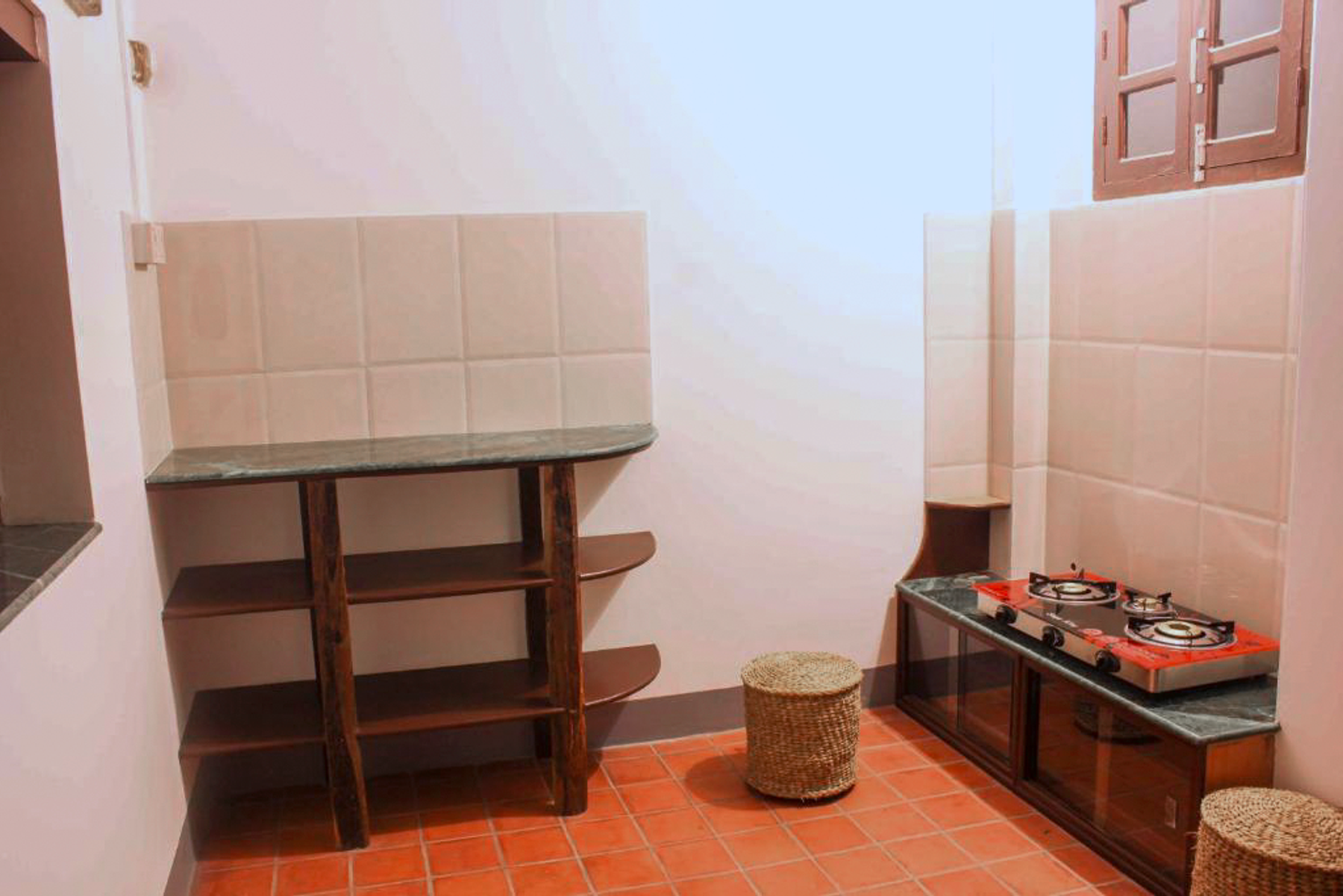 Mahakali kitchen counter with shelves and a stool