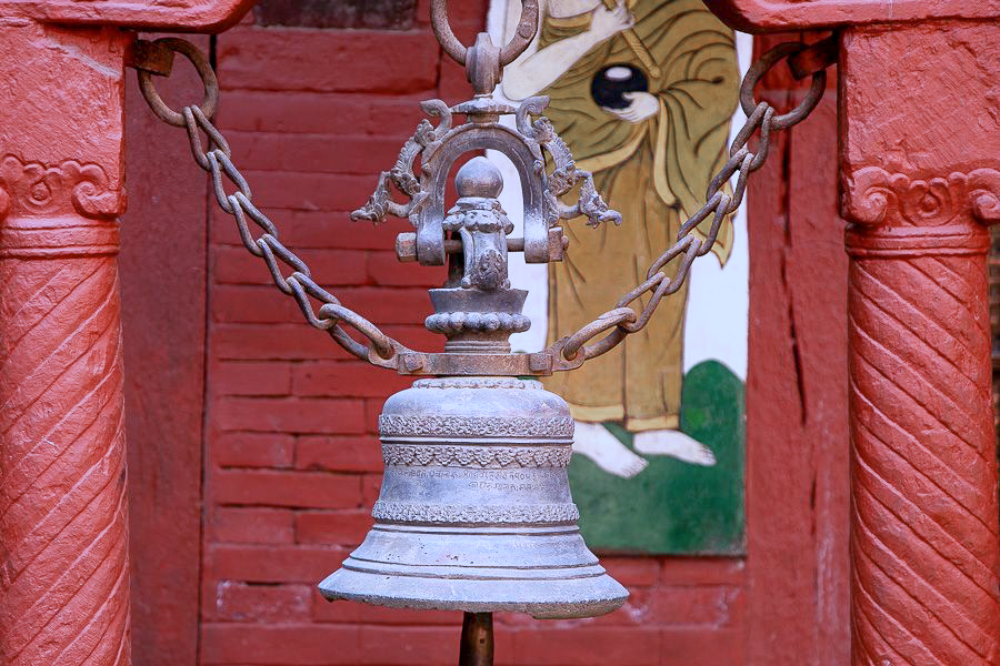 An old bronze temple bell in a Patan courtyard