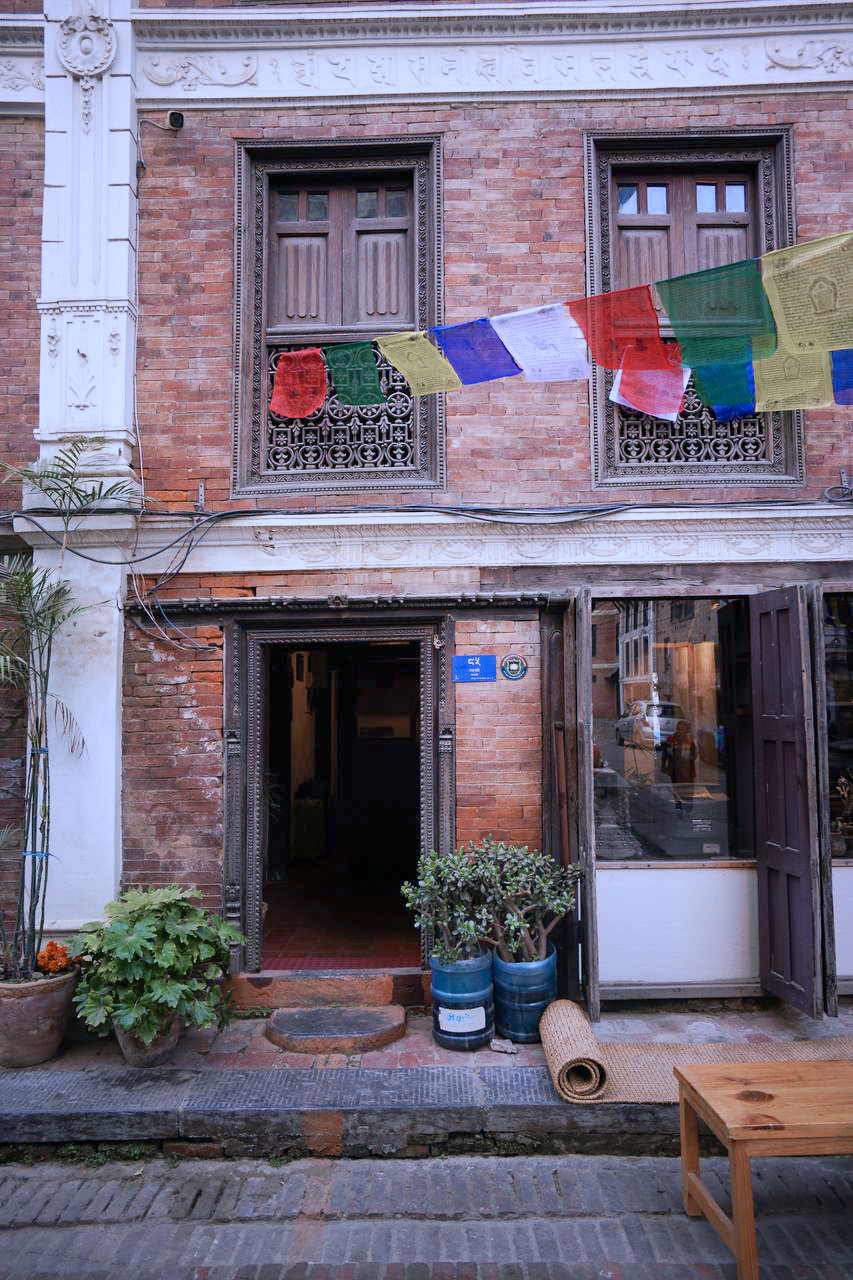 The brick courtyard of the guest house in early morning light