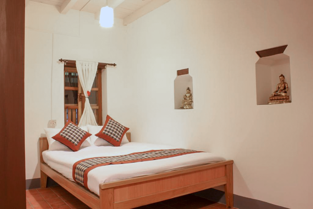 Mahakali double bed beneath the sloping attic ceiling
