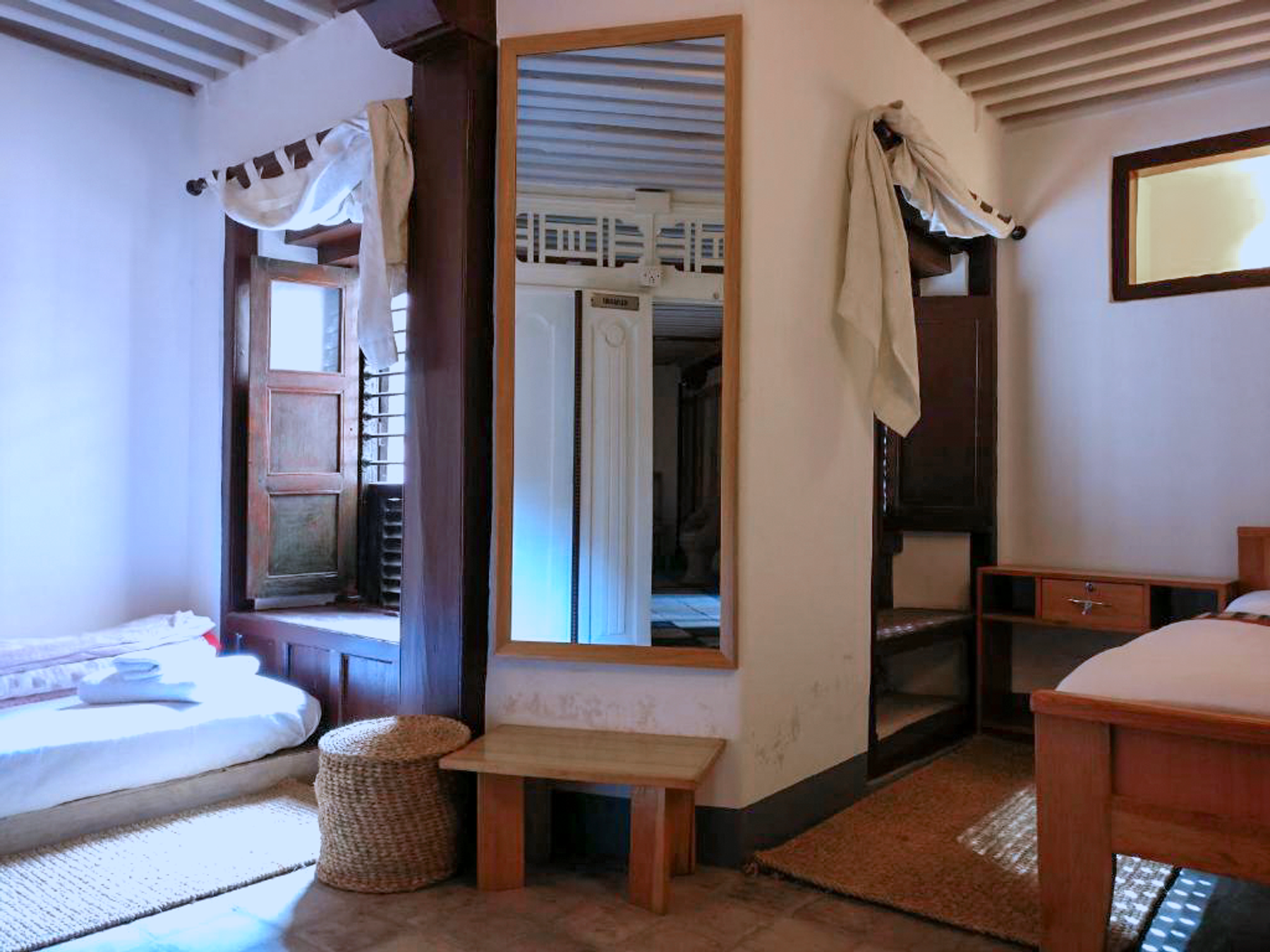 Kumari mirrored wardrobe between the floor mattress and single bed