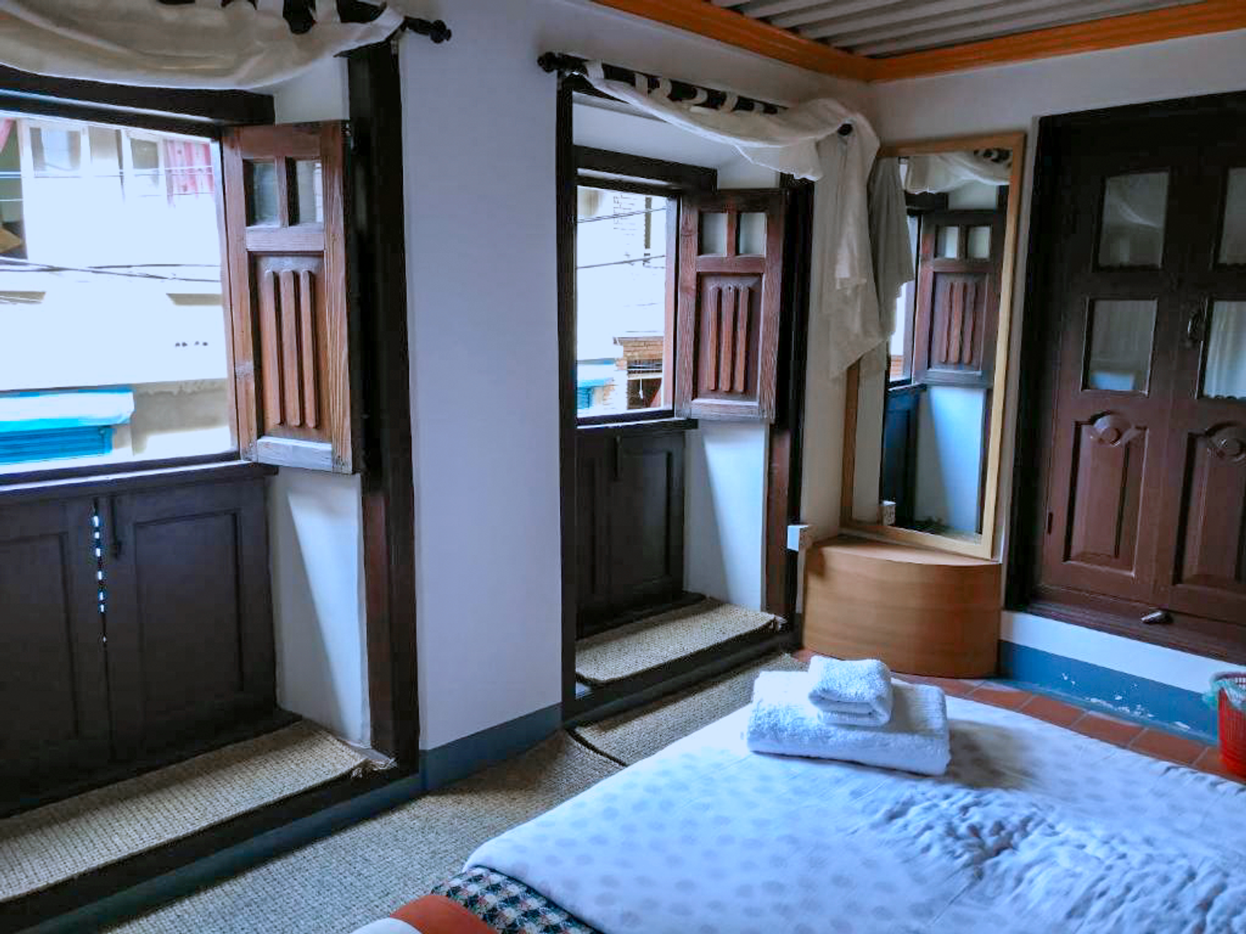 Vaishnavi wooden windows beside the bed, mirror and wardrobe