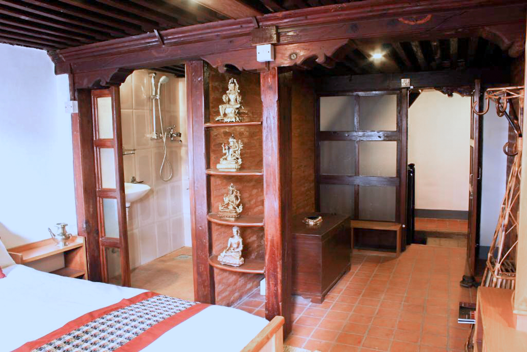 Rudrayani room with a wooden shelving column and wardrobe