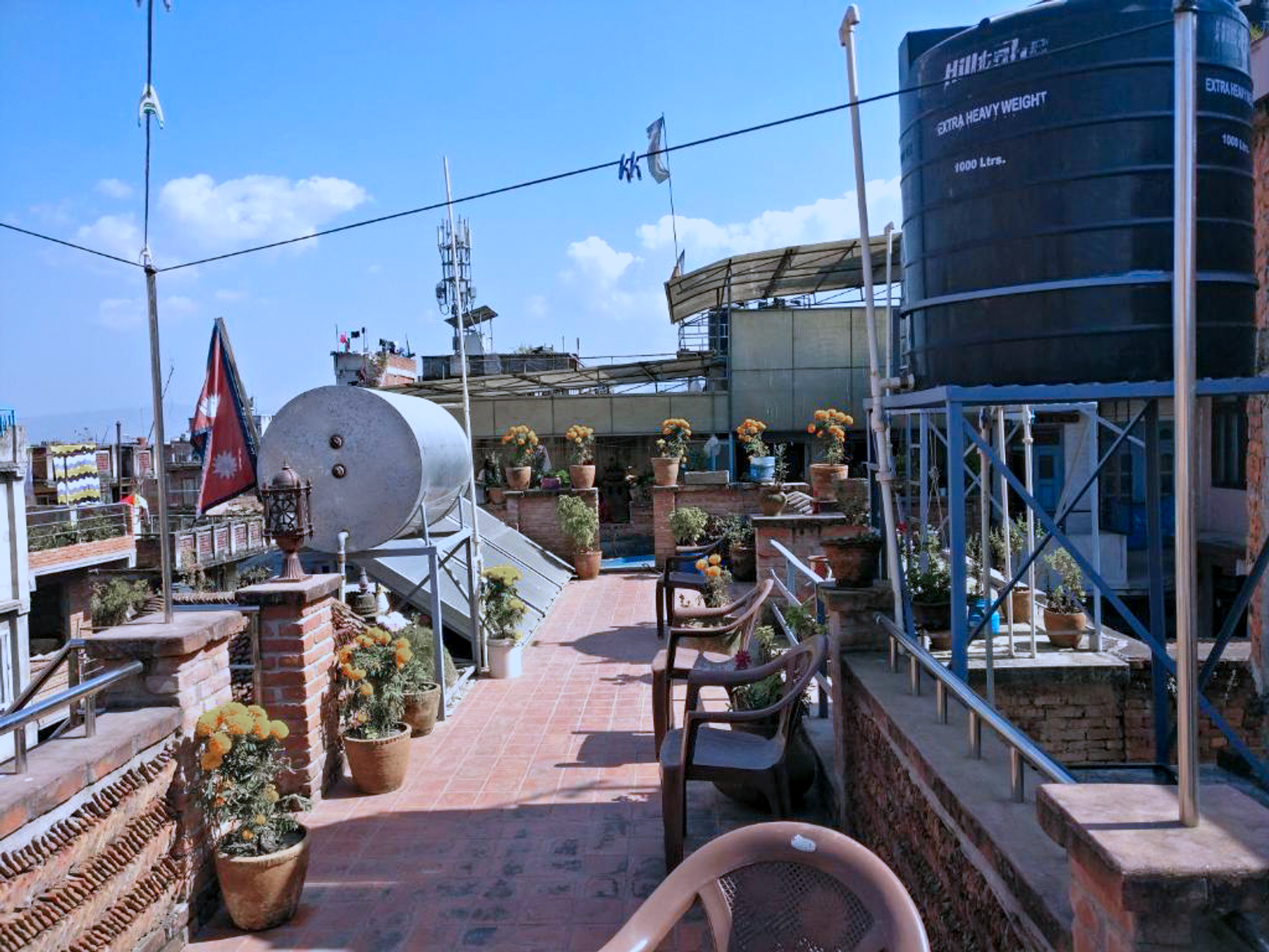 Potted plants and seating on the shared apartment rooftop