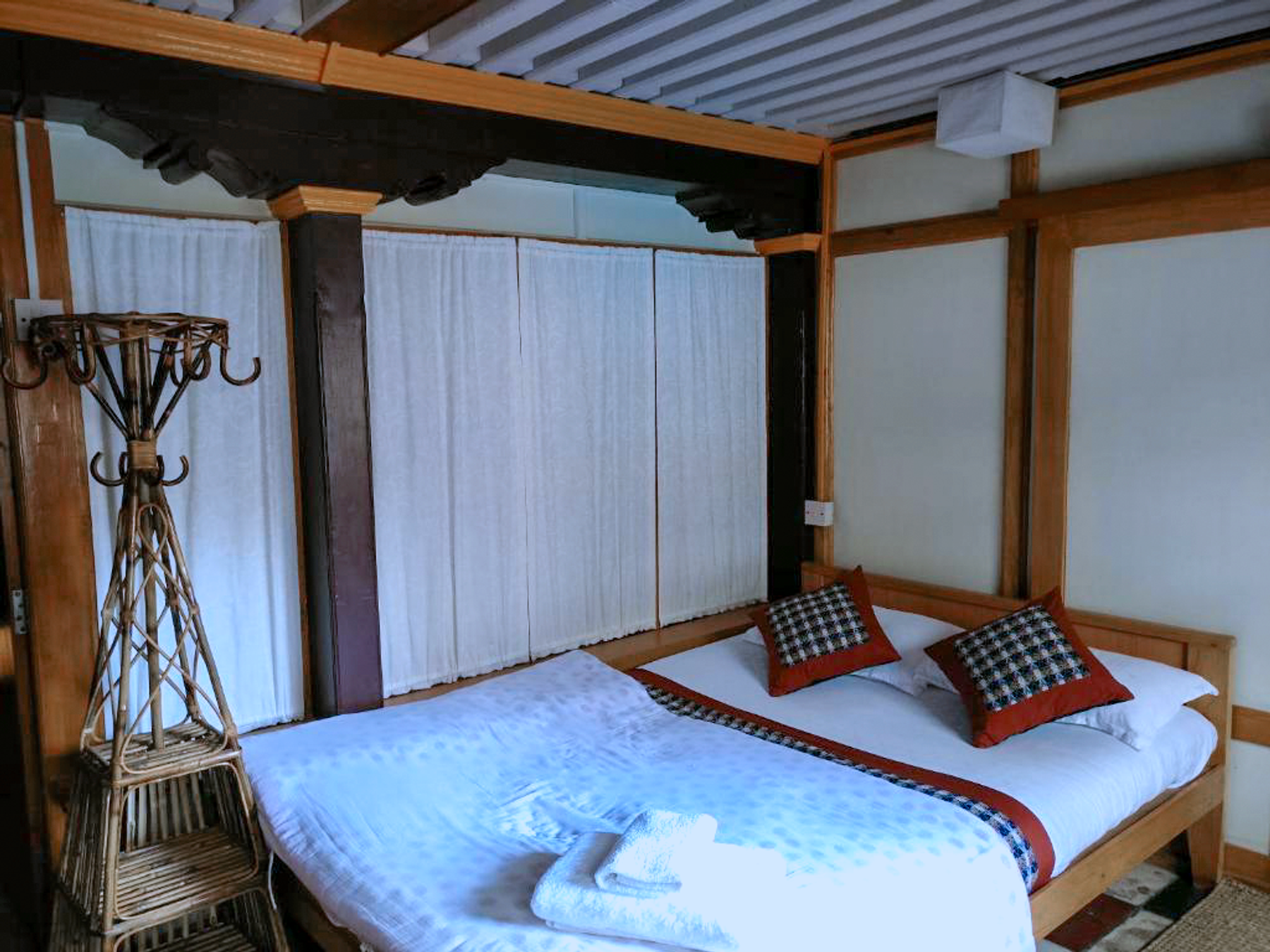 Vaishnavi double bed with cushions beneath exposed beams