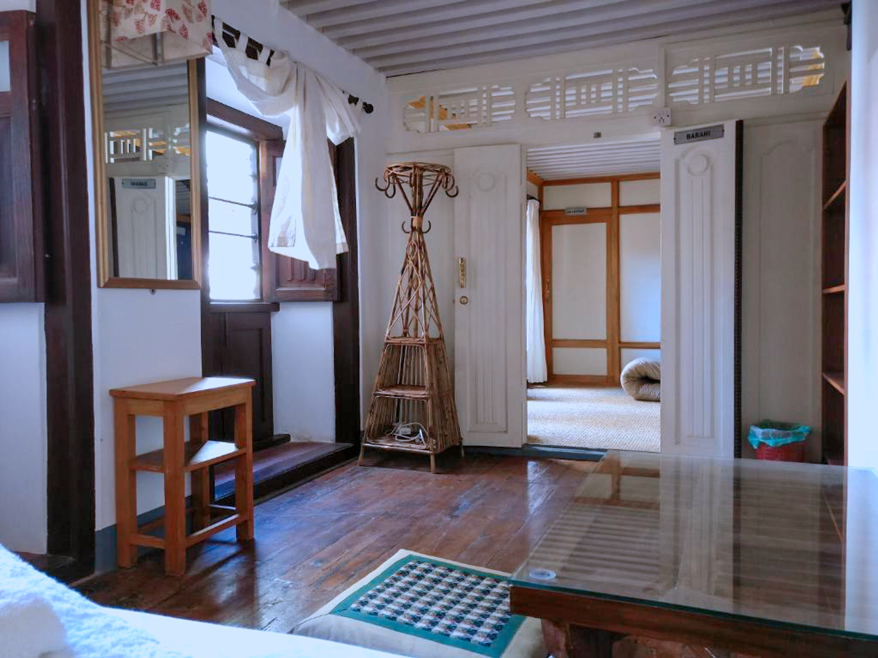 Barahi room looking toward the entrance, mirror and small table