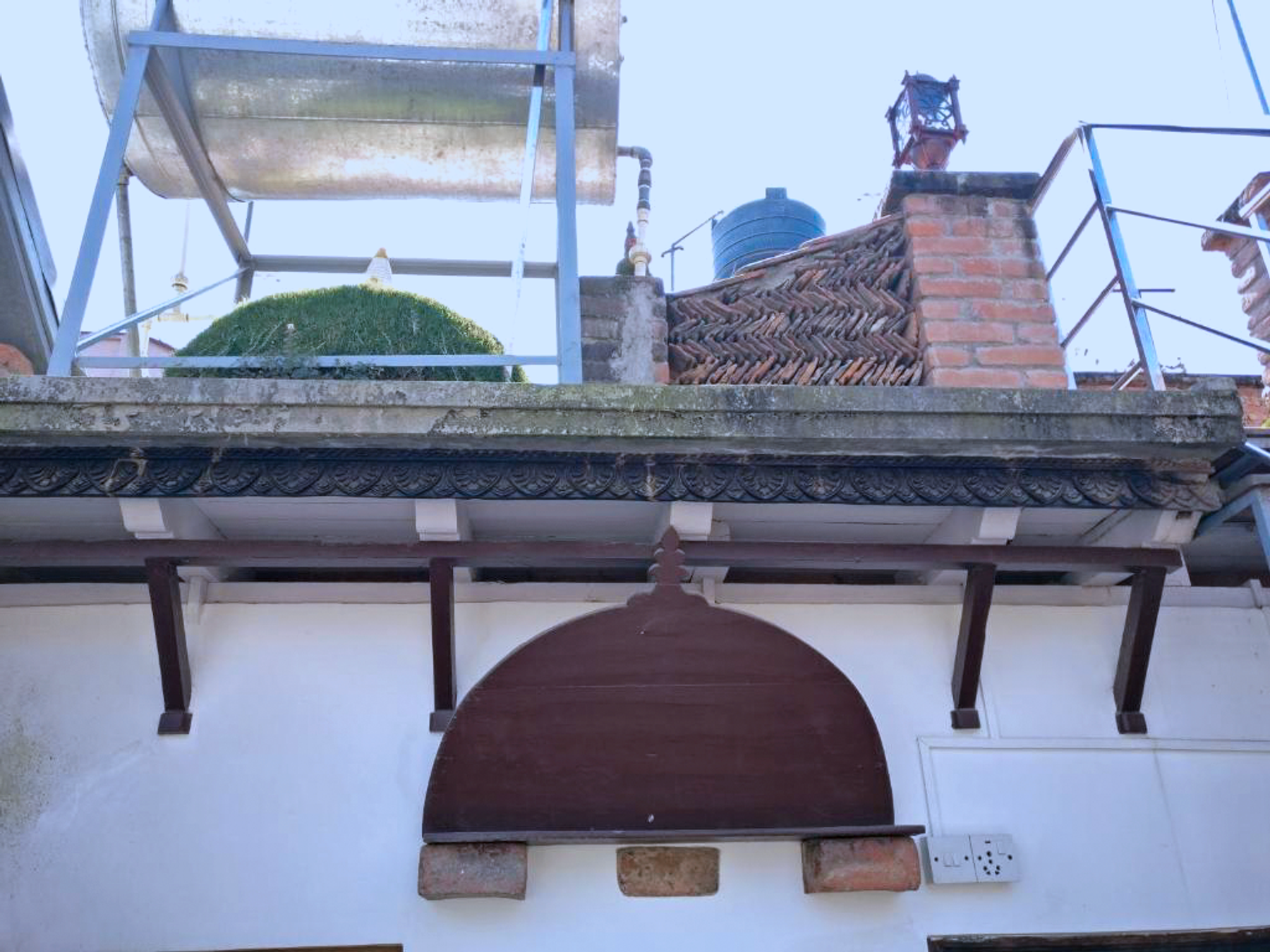 Temple roof and bell seen from the shared apartment rooftop