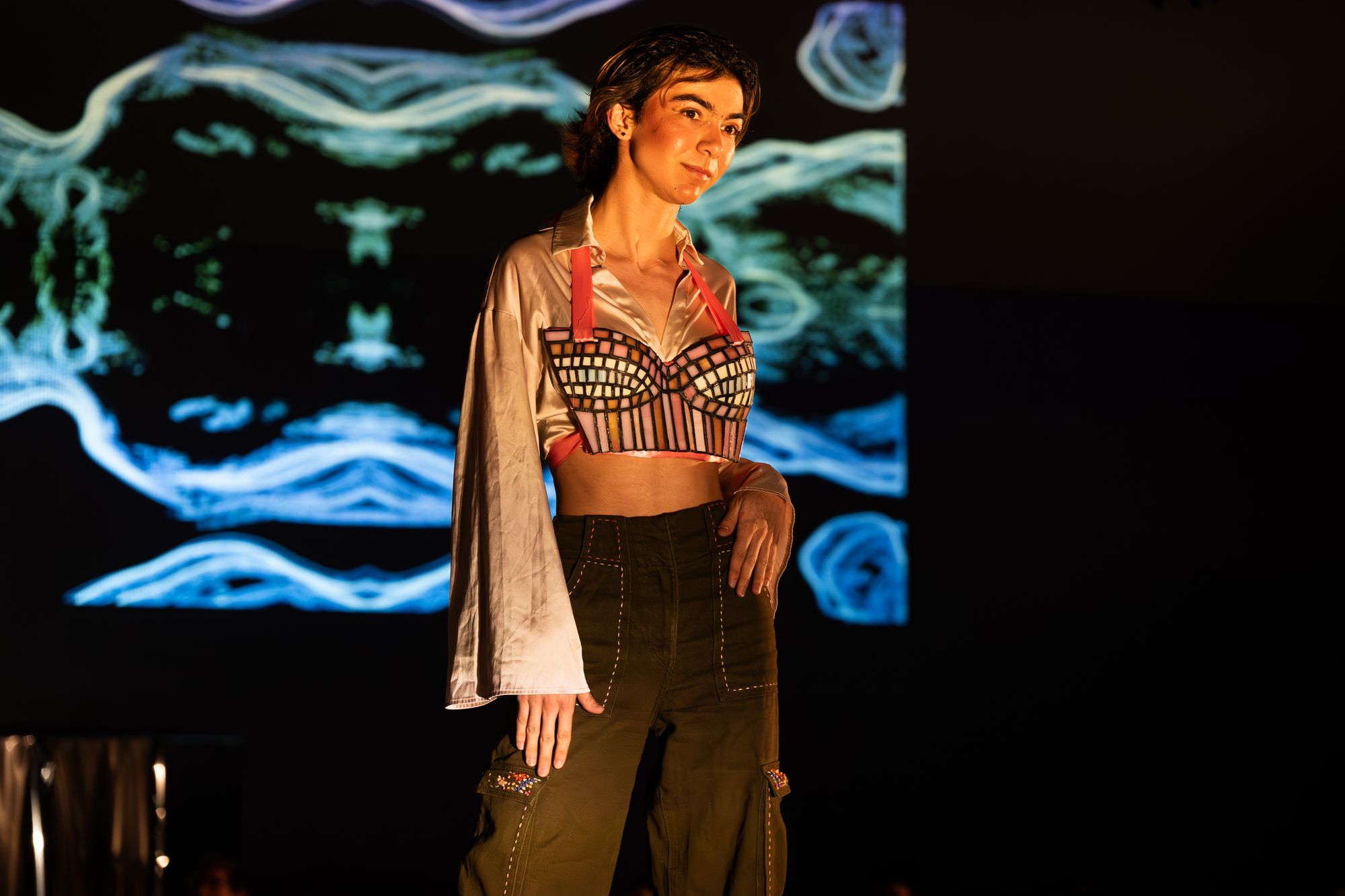 To fabricate "Aphrodite," Yoshi soldered a stained glass corset onto a plaster mold of her torso, taking about 45 hours. Modeled by Rowan Dzwonkowski and styled with cargo pants, "Aphrodite" explores "a gender neutral vision of the goddess of love." Photo: Jules Dail