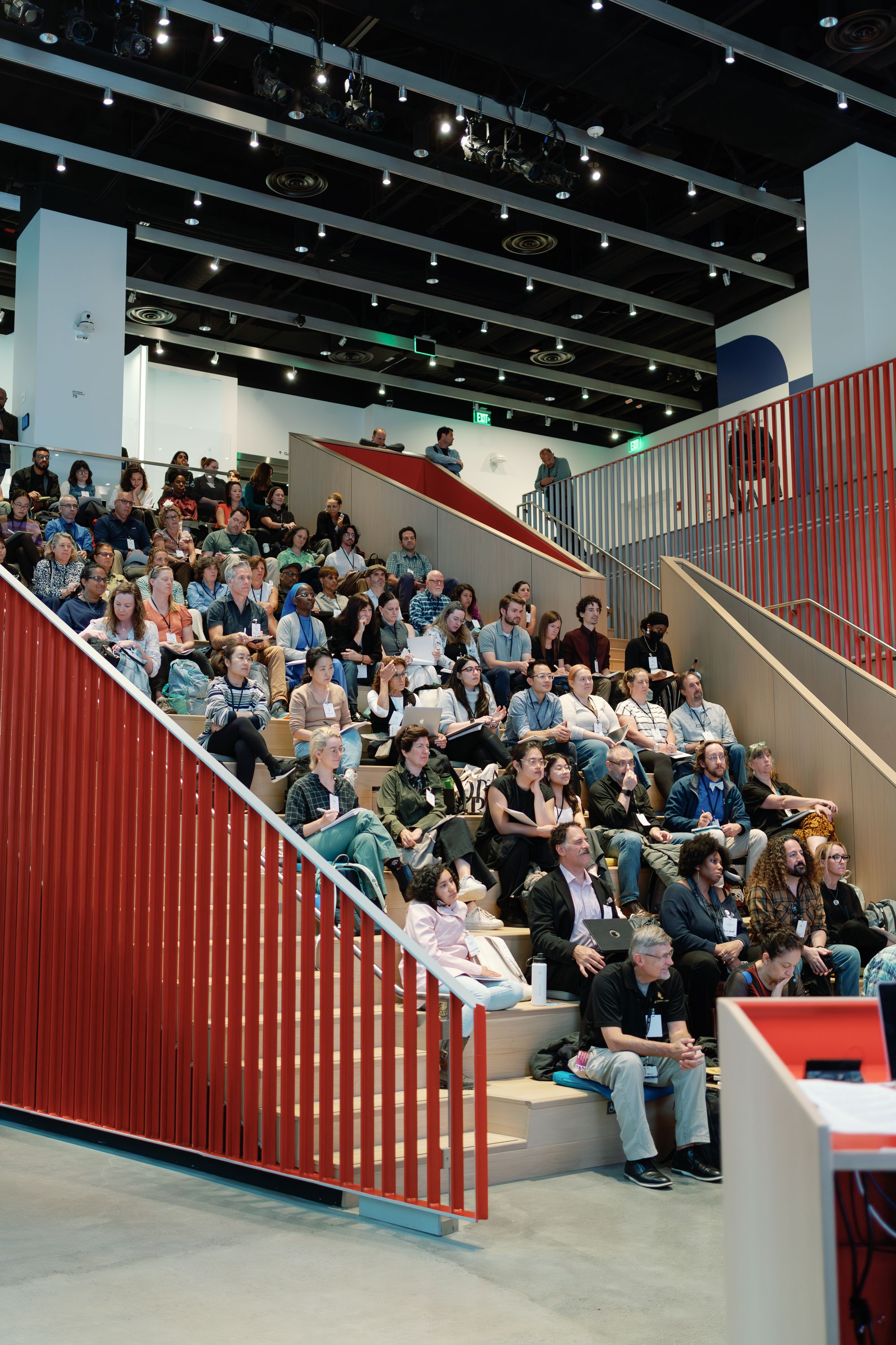 Participants watch the panel discussion from the MIT Museum's tiered seats.