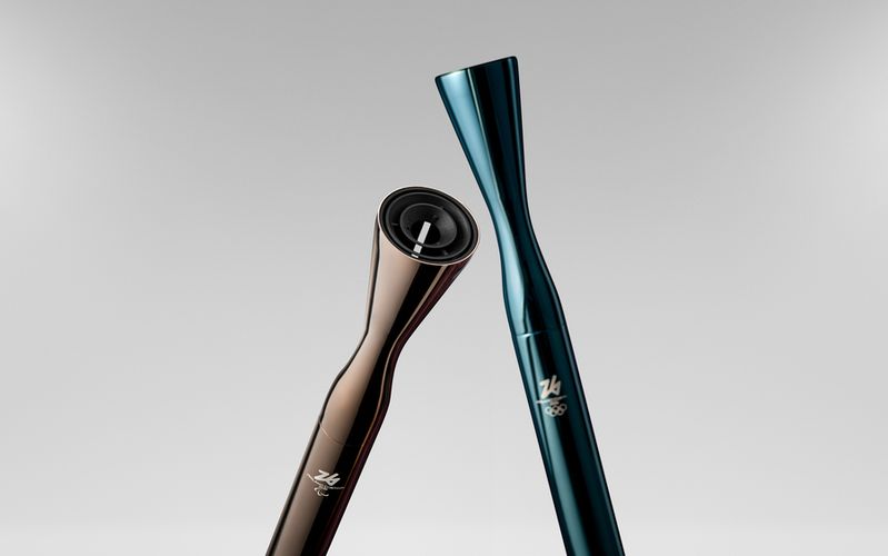 Two sleek metallic cylindrical torches, each with a flare at the end. One is gray and one is teal.