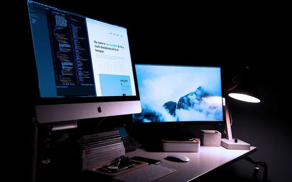 Two desktop mac screens against a dark background