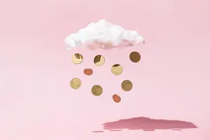 Cloud on a pink background with coins raining down