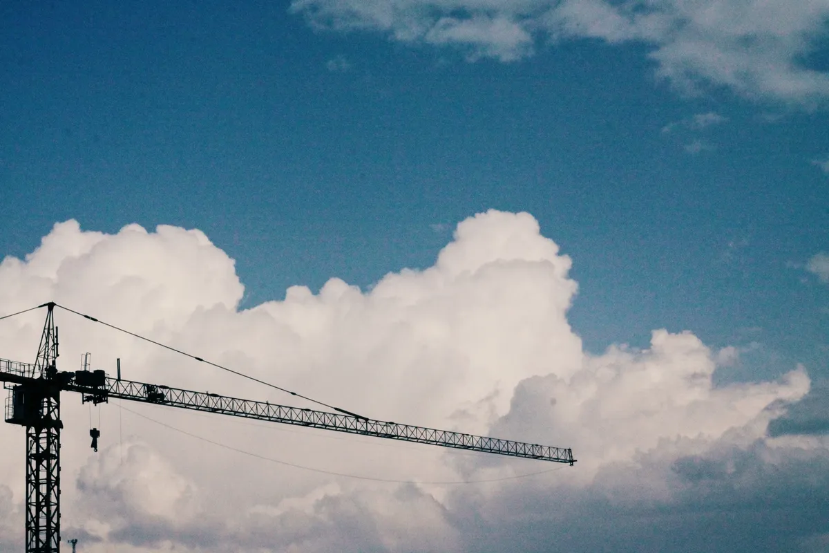 A crane with clouds in the background
