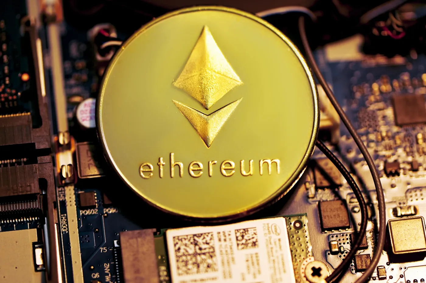 Gold ethereum coin on a circuit board background