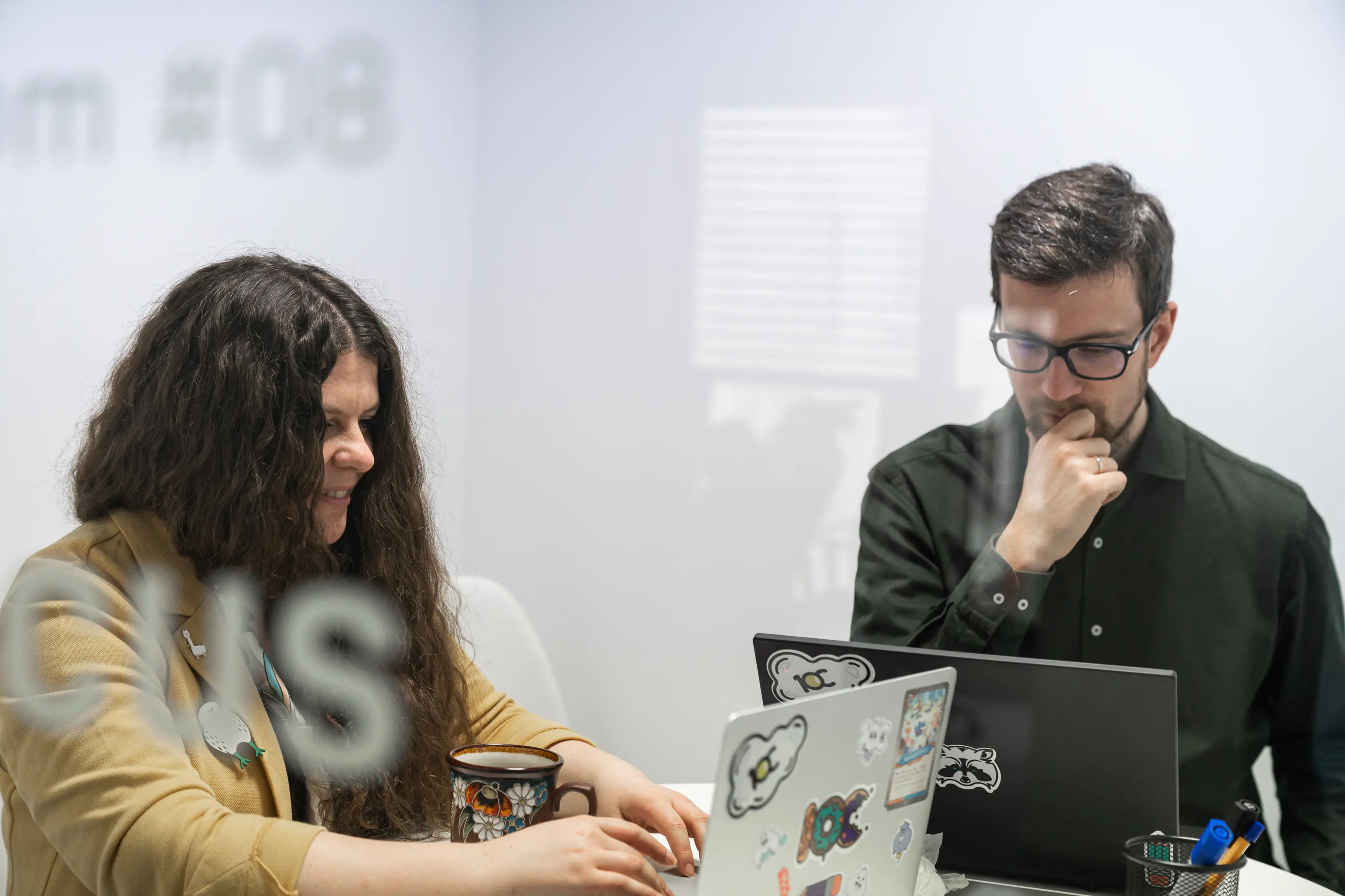 Two software testers in a meeting room