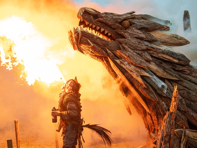 Wooden dragon sculpture with a fire breather 