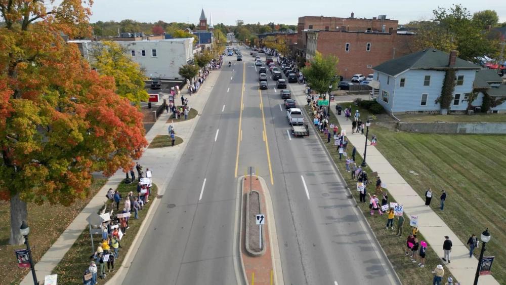 An east-facing drone image showing peaceful protesters stretched far down Michigan Ave