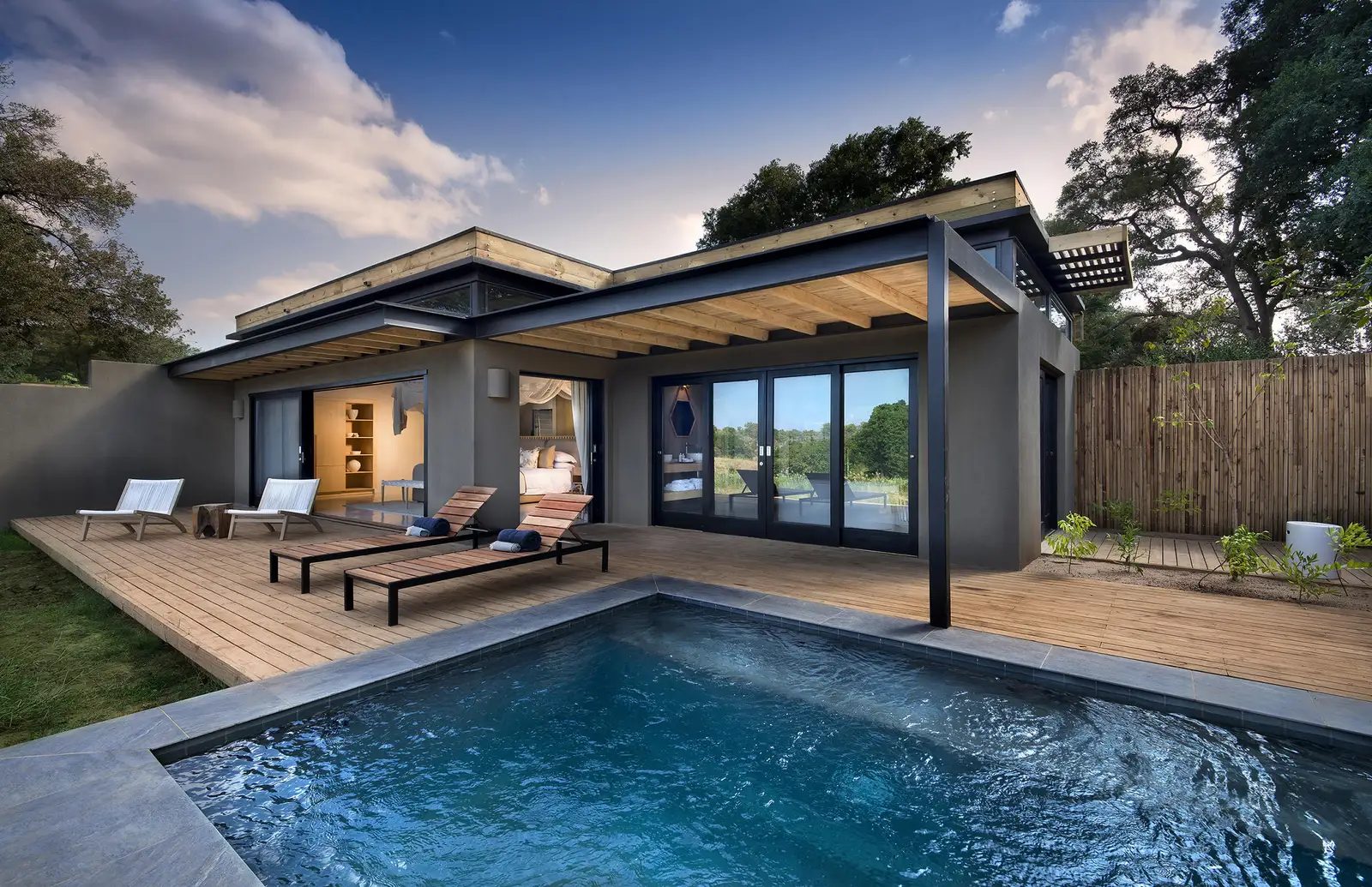 Lion Sands River Lodge river suite exterior with timber deck, loungers and private pool