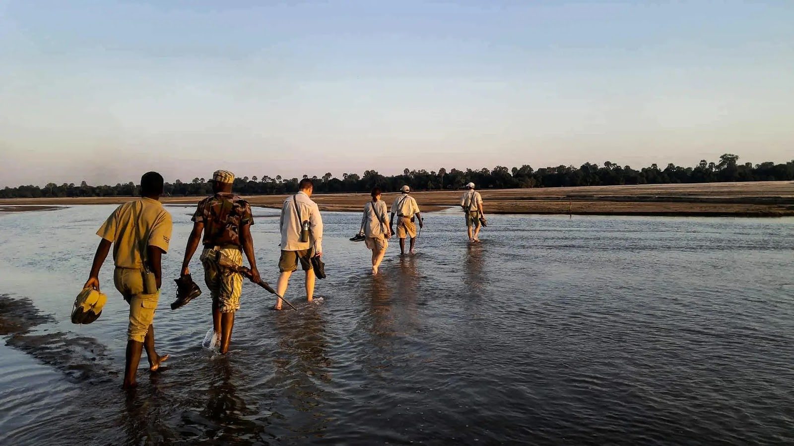 Guides accompany guests on a walk in South Luangwa National Park, Zambia.