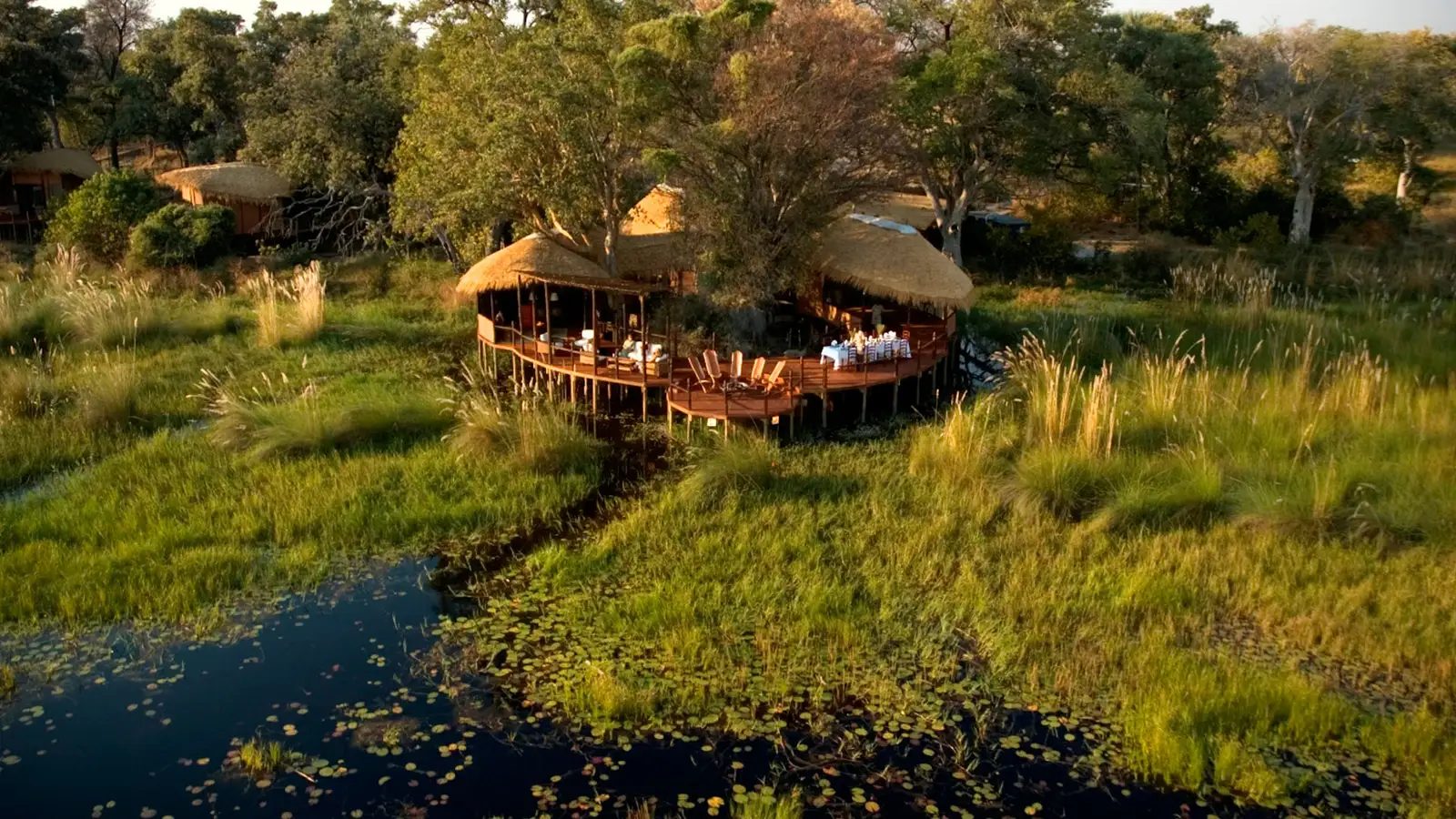 Baine's Camp nestled amongst lush greenery and water.