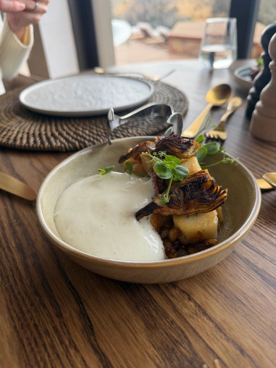Rosemary gnocchi with fried artichokes and Parmesan foam in a stoneware bowl at Kuganha