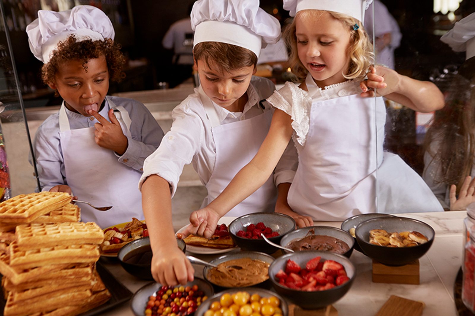 Kids enjoying their baking lesson with the pastry chef