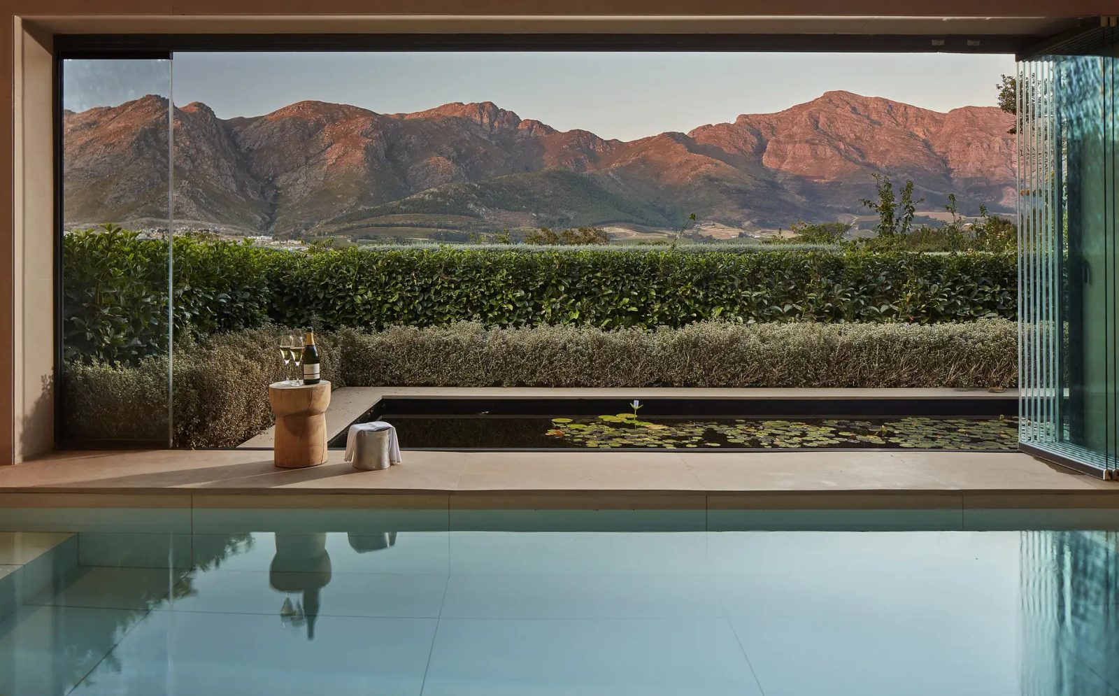 A wine estate and pool beneath the mountains of the Cape Winelands