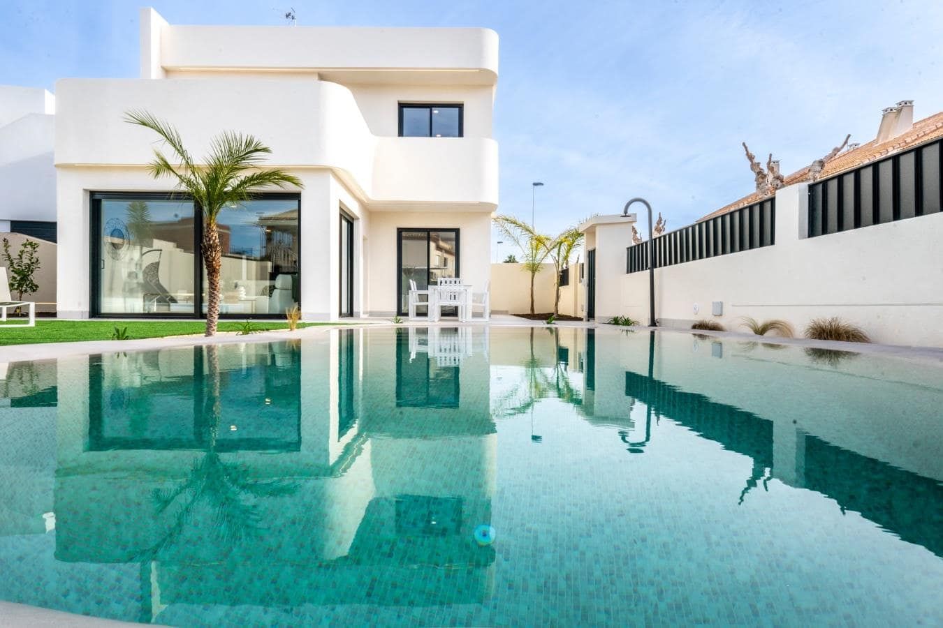 Contemporary villa exterior reflected in the swimming pool