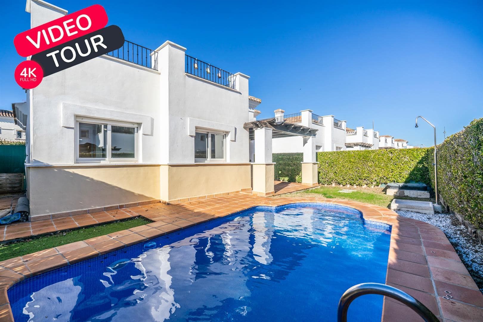 Swimming pool and white villa exterior with a VIDEO TOUR 4K graphic.