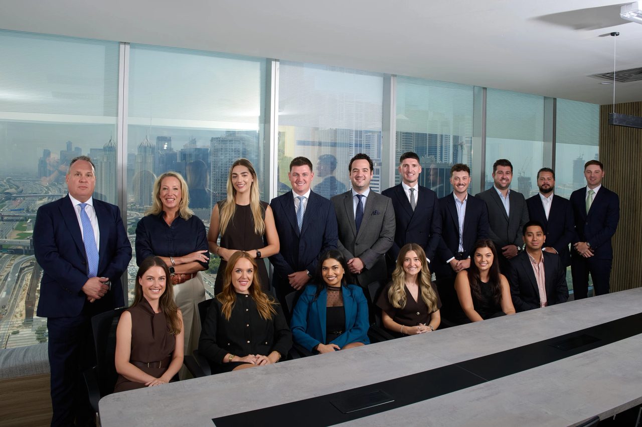 The SPF UAE team in a boardroom overlooking the Dubai skyline