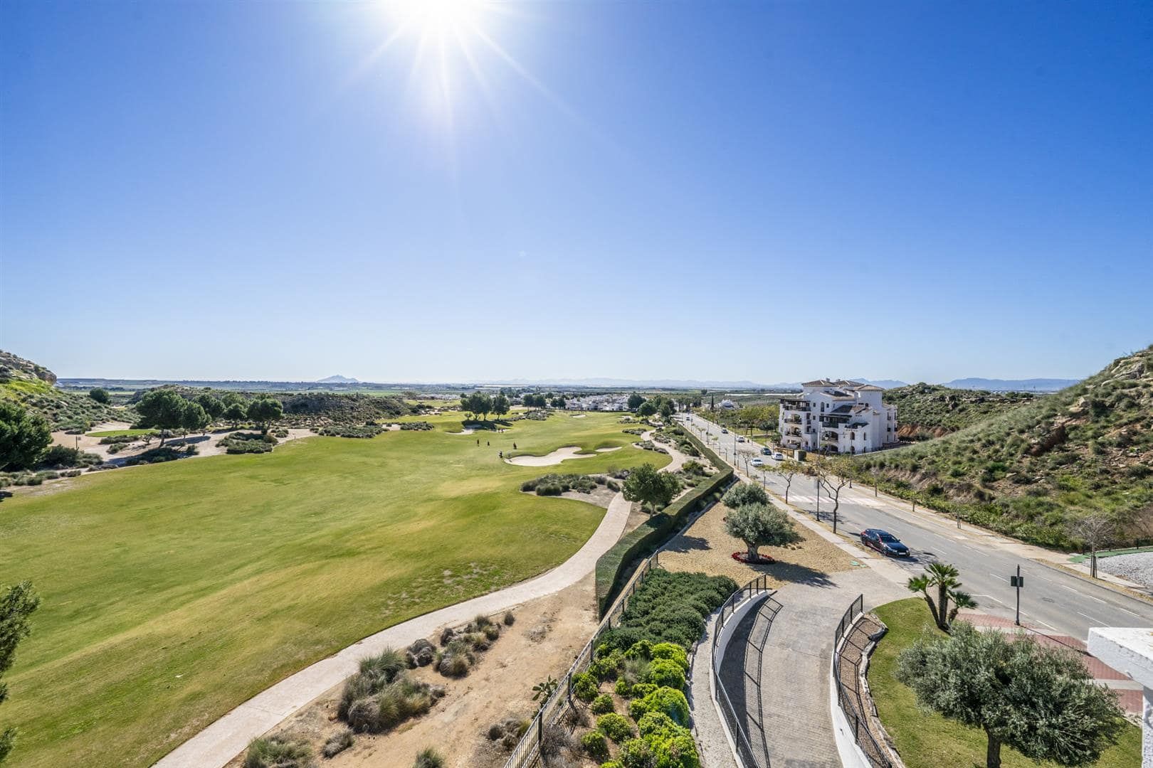 Elevated view across the golf course and surrounding landscape