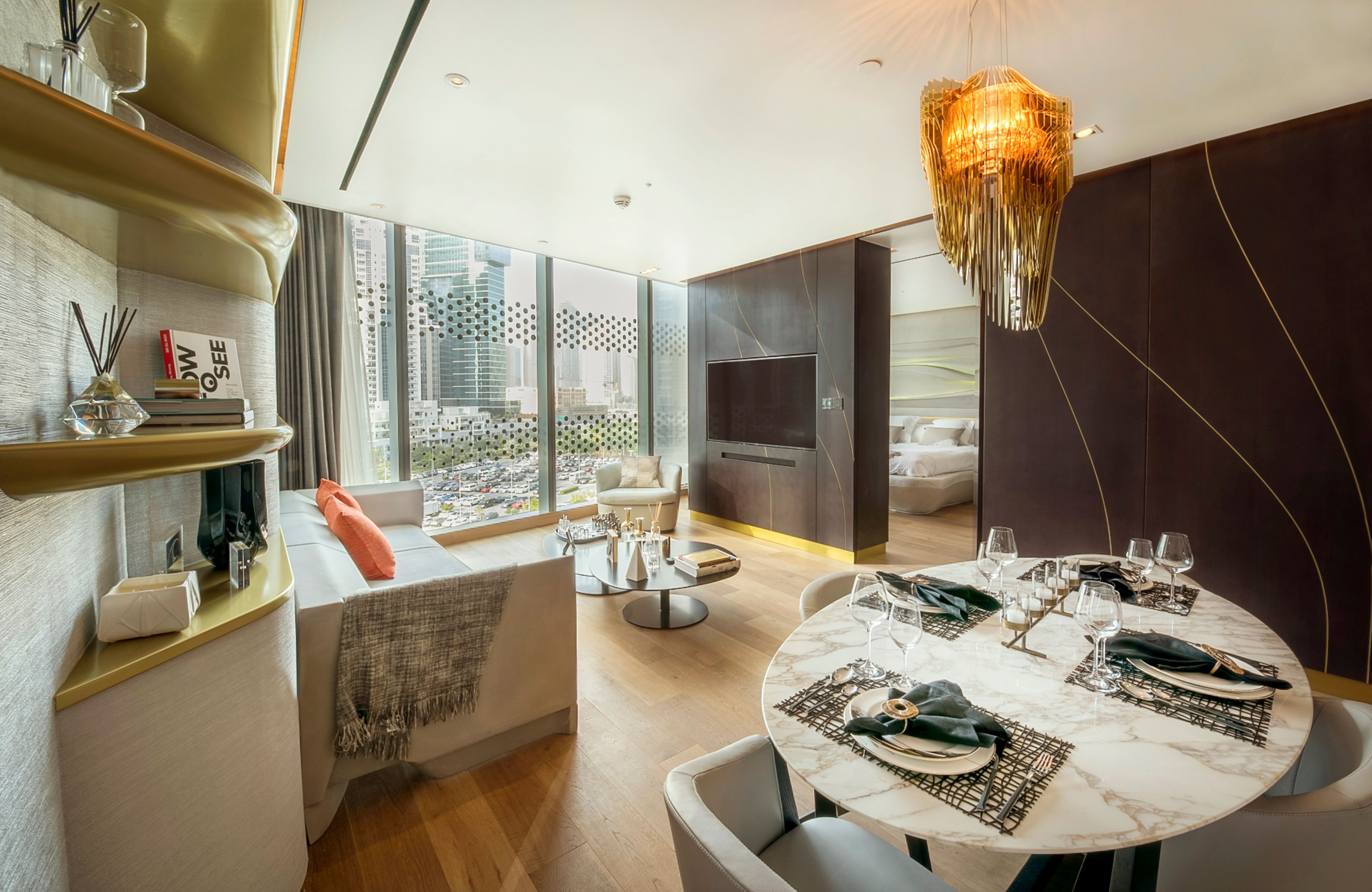 Open-plan dining and living space in a representative one-bedroom show residence at The Opus.