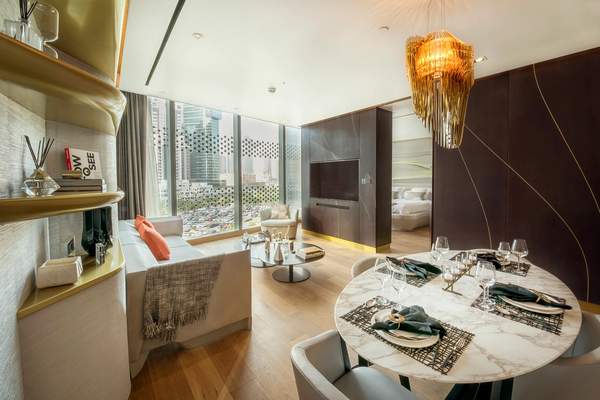 Open-plan dining and living space in a representative one-bedroom show residence at The Opus.