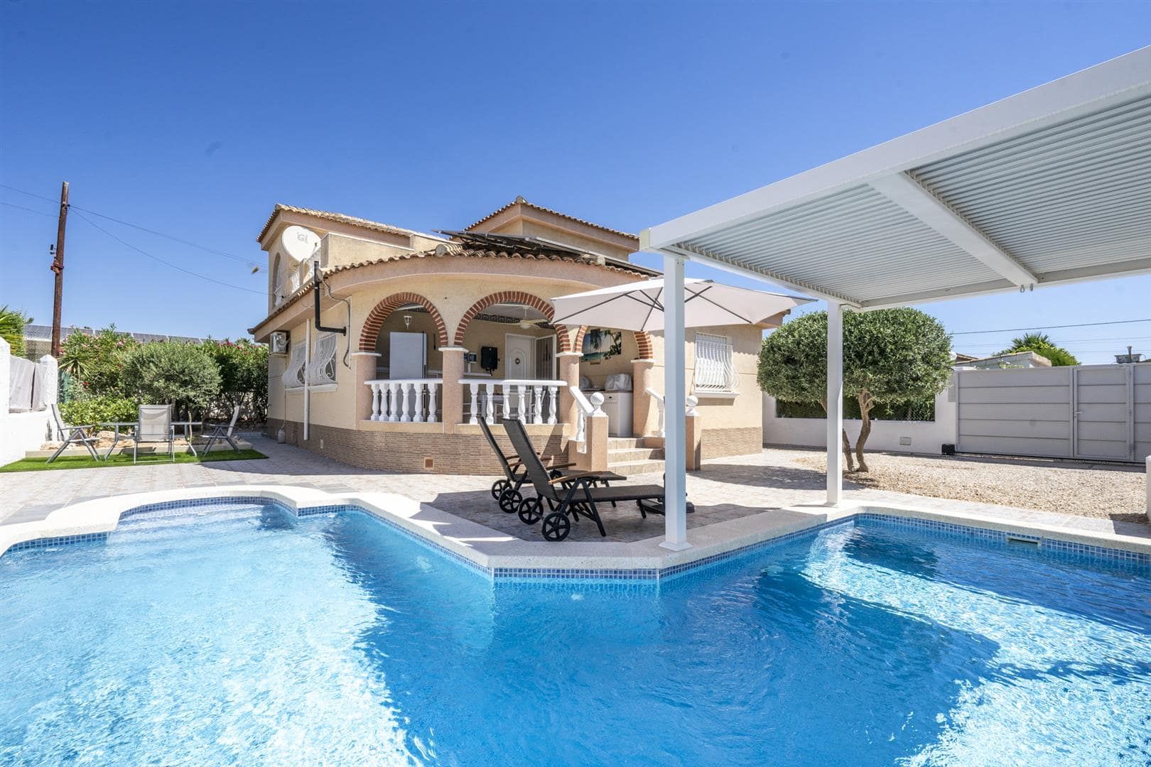 Villa exterior with private pool and shaded terrace