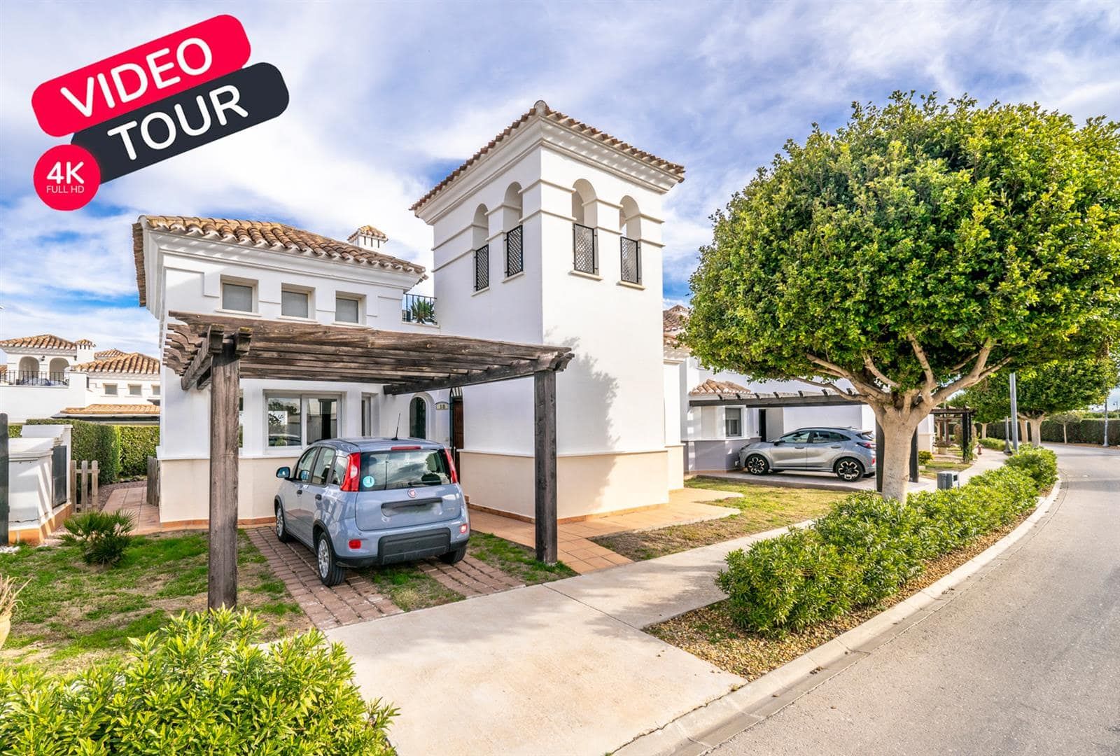 Villa exterior and pergola with an applied video tour graphic
