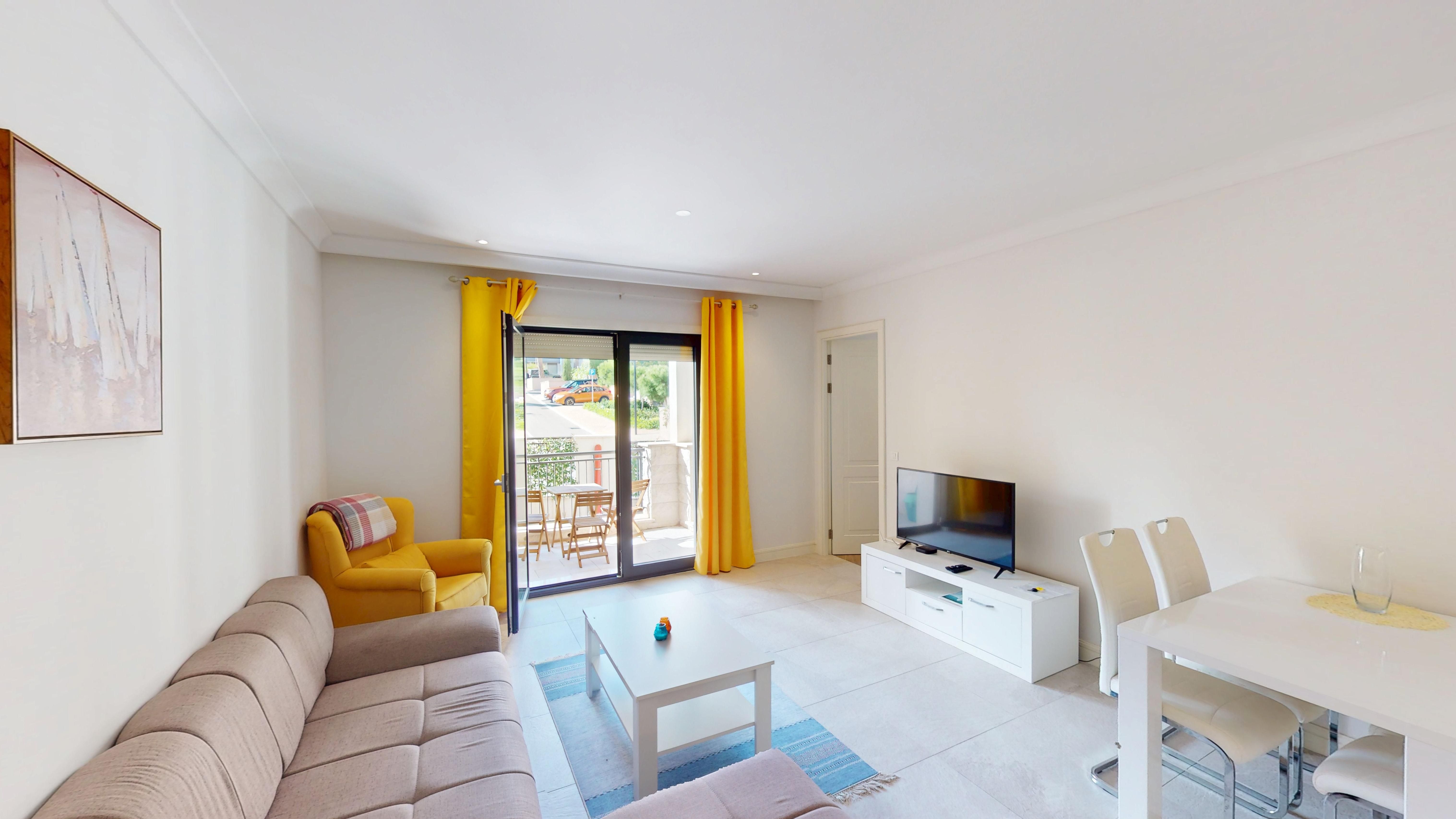 Open-plan lounge and dining area opening to the balcony at Apartment 4203 in Centrale, Luštica Bay