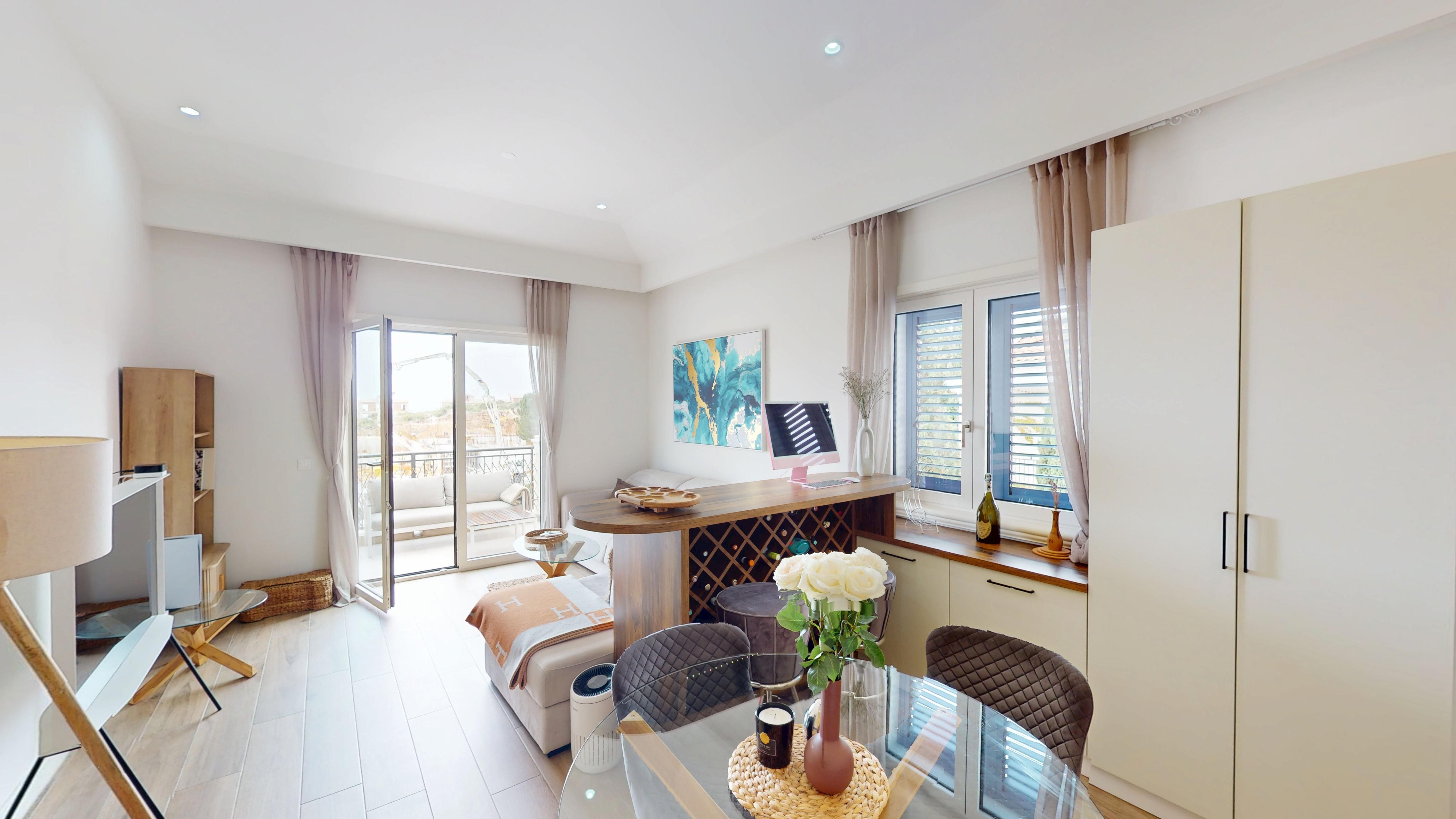 Open-plan living and dining room opening to the balcony at Apartment 3b334 in Centrale, Luštica Bay