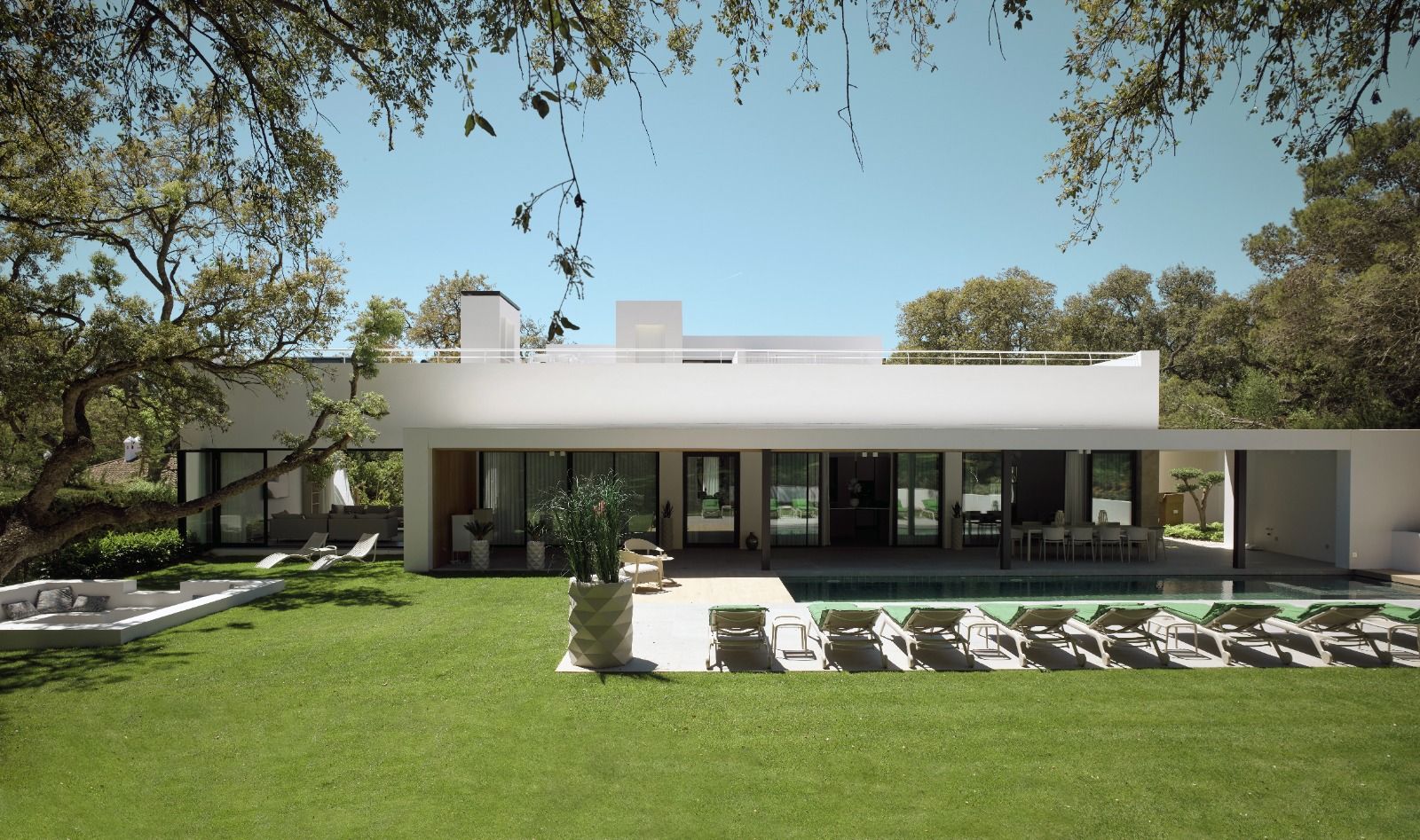 Rear garden facade, sun loungers and partially visible pool