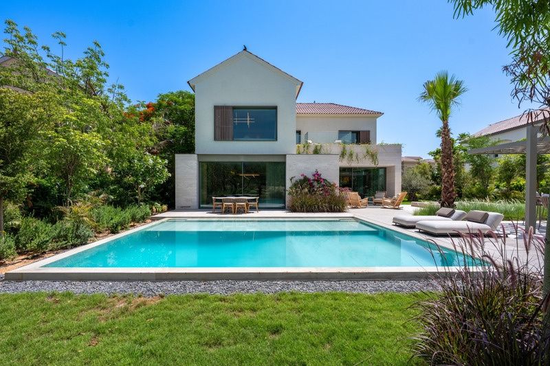 Pool and rear villa exterior in daylight at Redwood Avenue, Jumeirah Golf Estates, Dubai