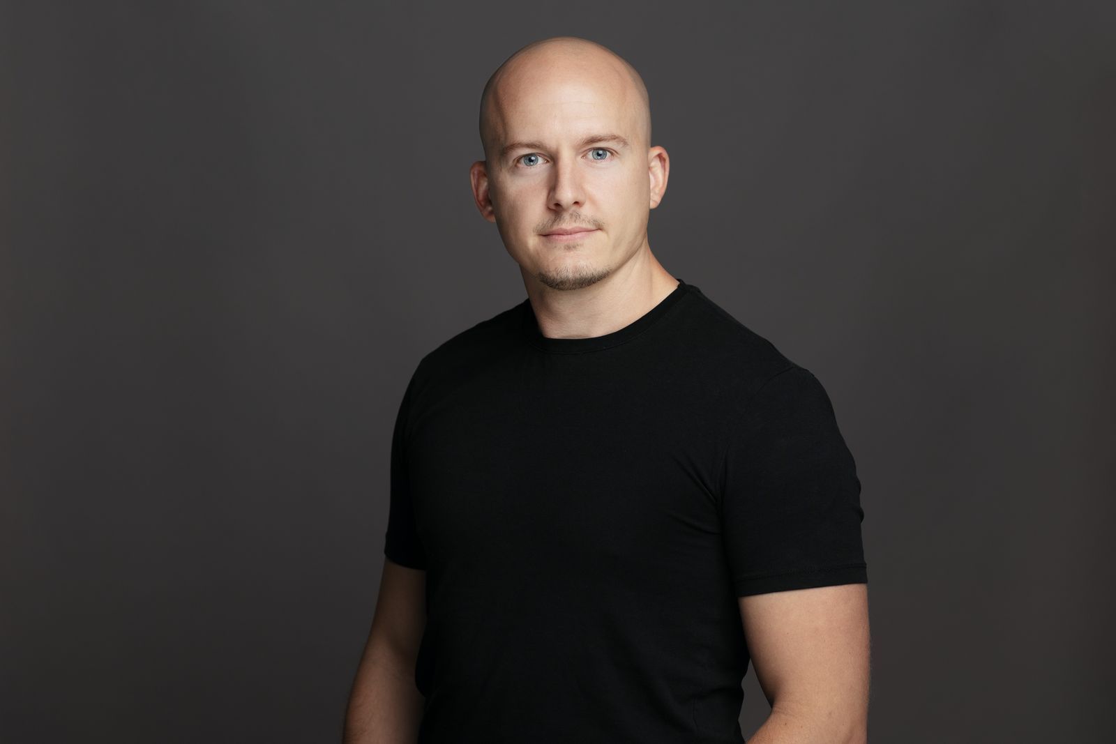 Portrait of Alex Chapman, a Golf Homes International team member.