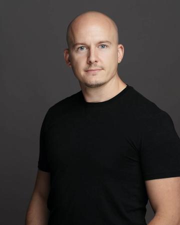 Portrait of Alex Chapman, a Golf Homes International team member.
