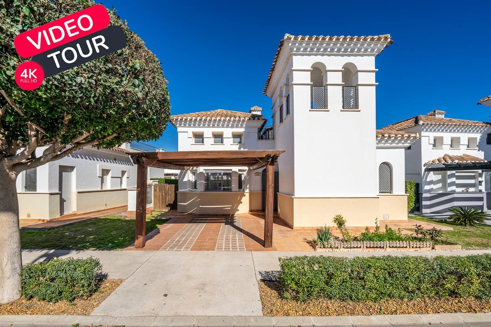 Villa exterior and pergola with an applied video tour graphic