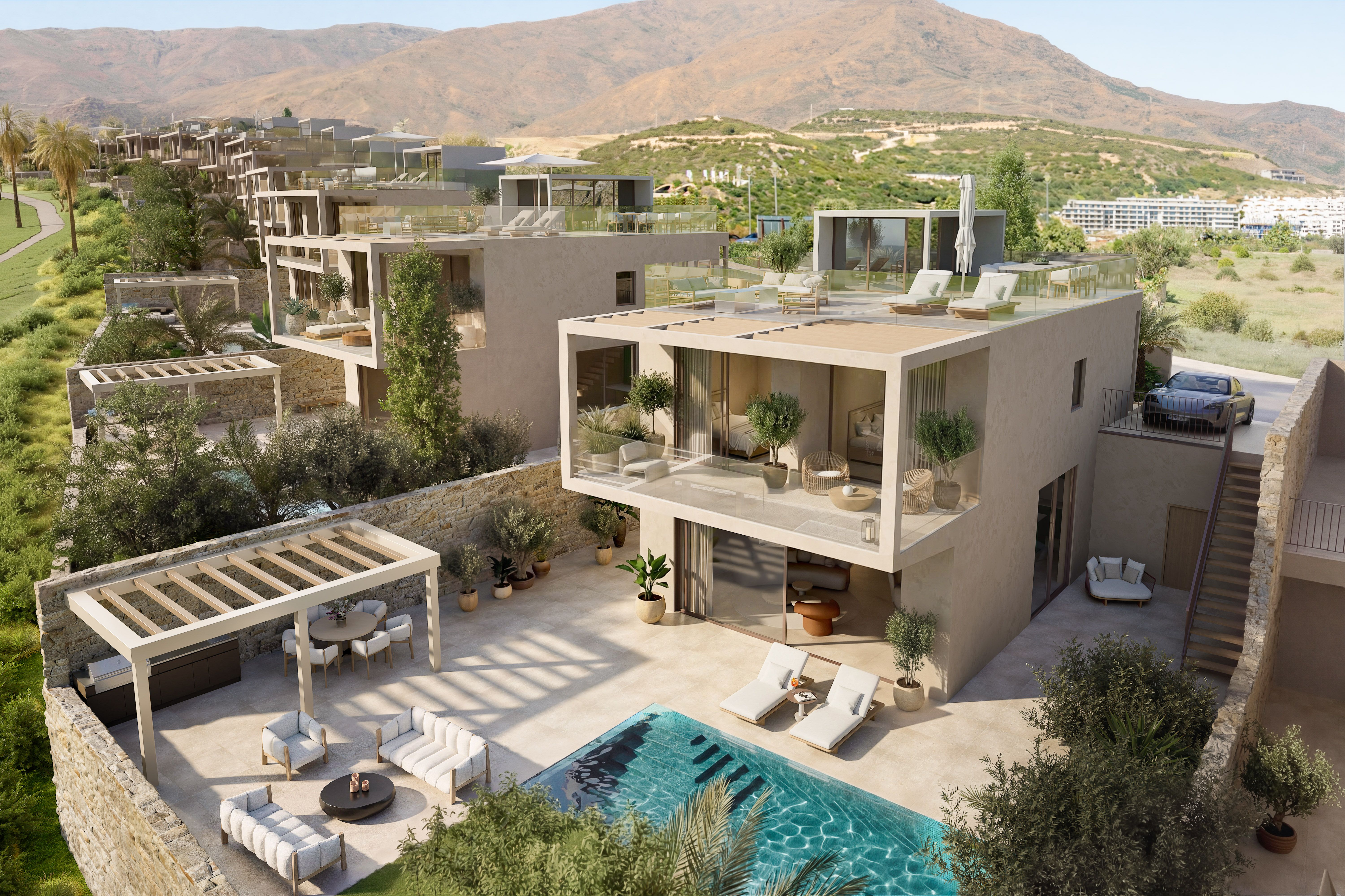 Aerial view of an Amaris villa with a private pool, landscaped terraces and Sierra Bermeja backdrop.