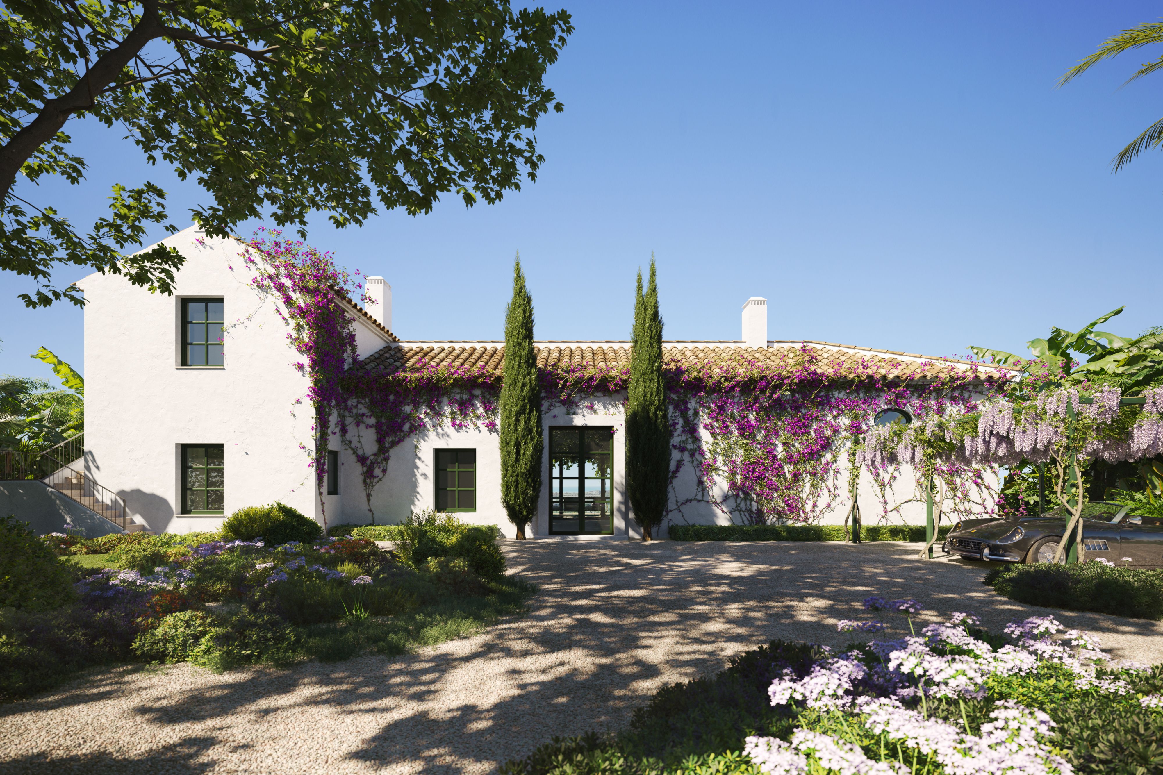 Cortijo 2 entrance facade framed by bougainvillea and Mediterranean planting