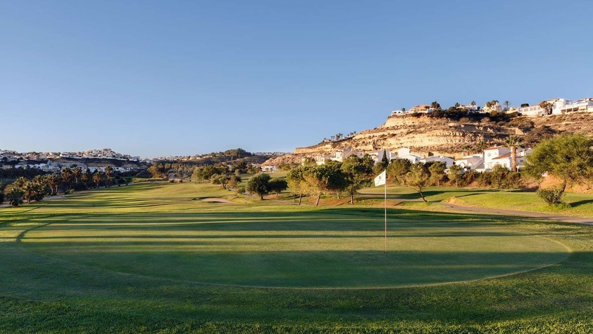 La Marquesa Golf green and fairway below the hills of Ciudad Quesada