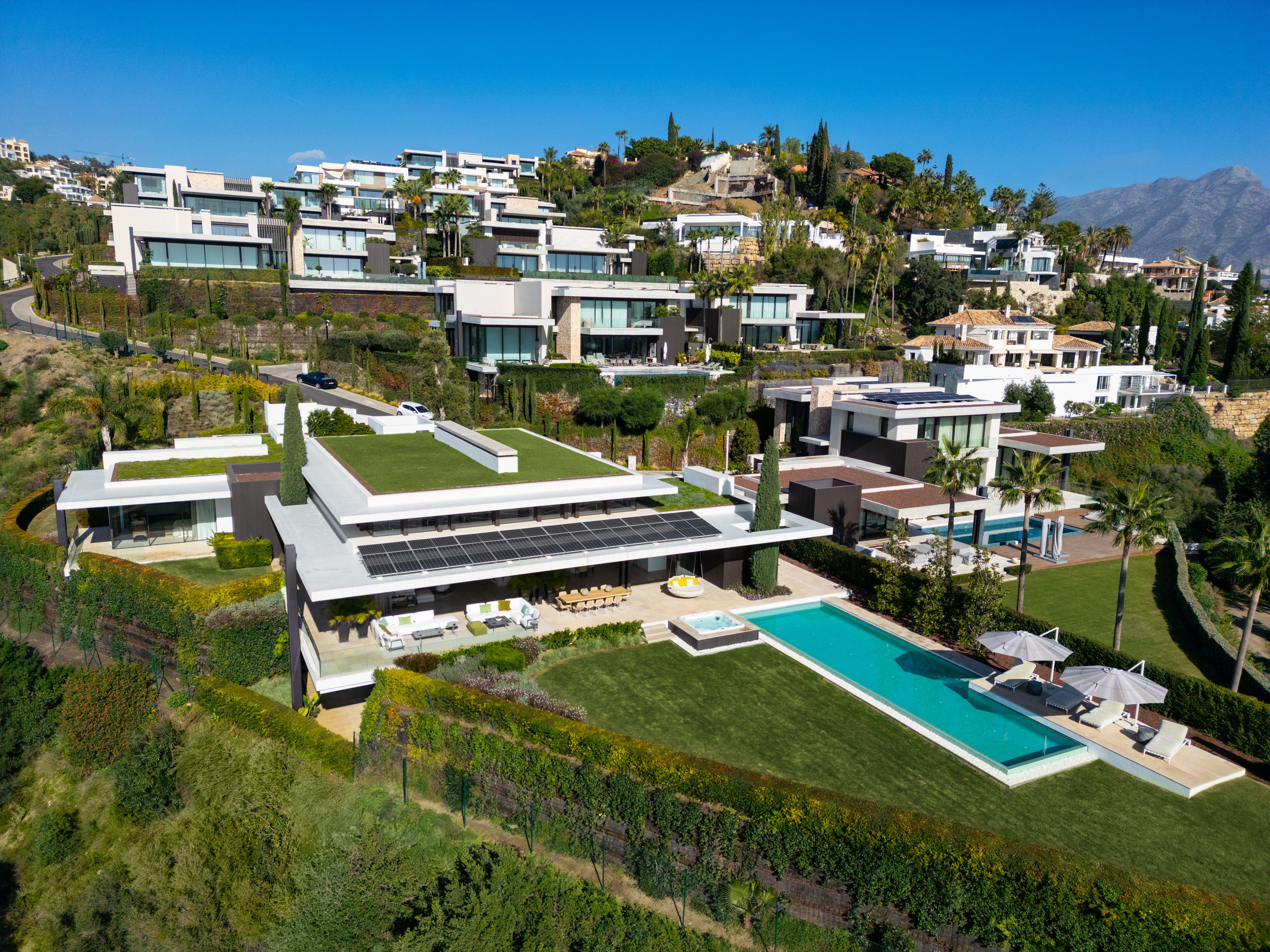 Aerial view of The Hills 1 villa, private pool and surrounding La Quinta hillside homes.