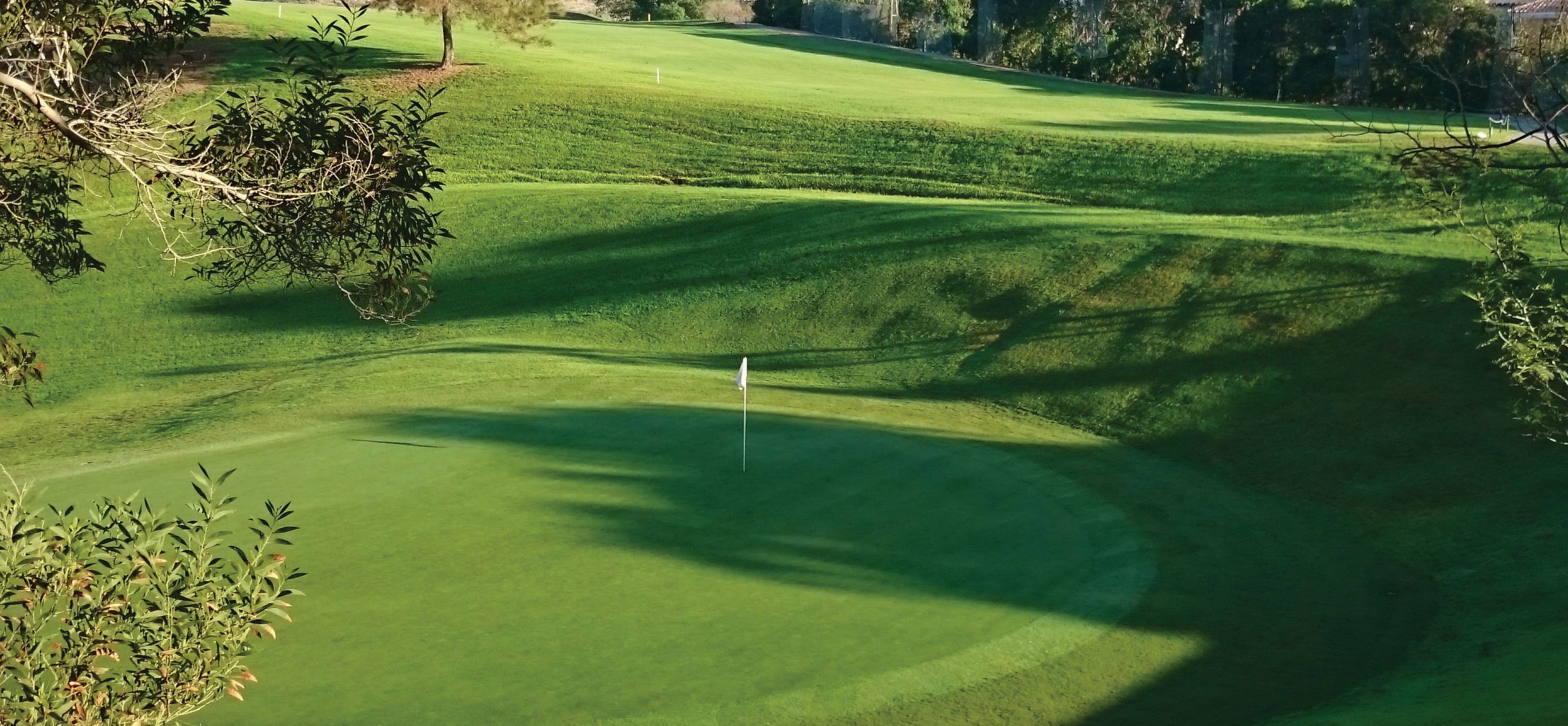 Green and surrounding fairways at Miraflores Golf Club in Riviera del Sol
